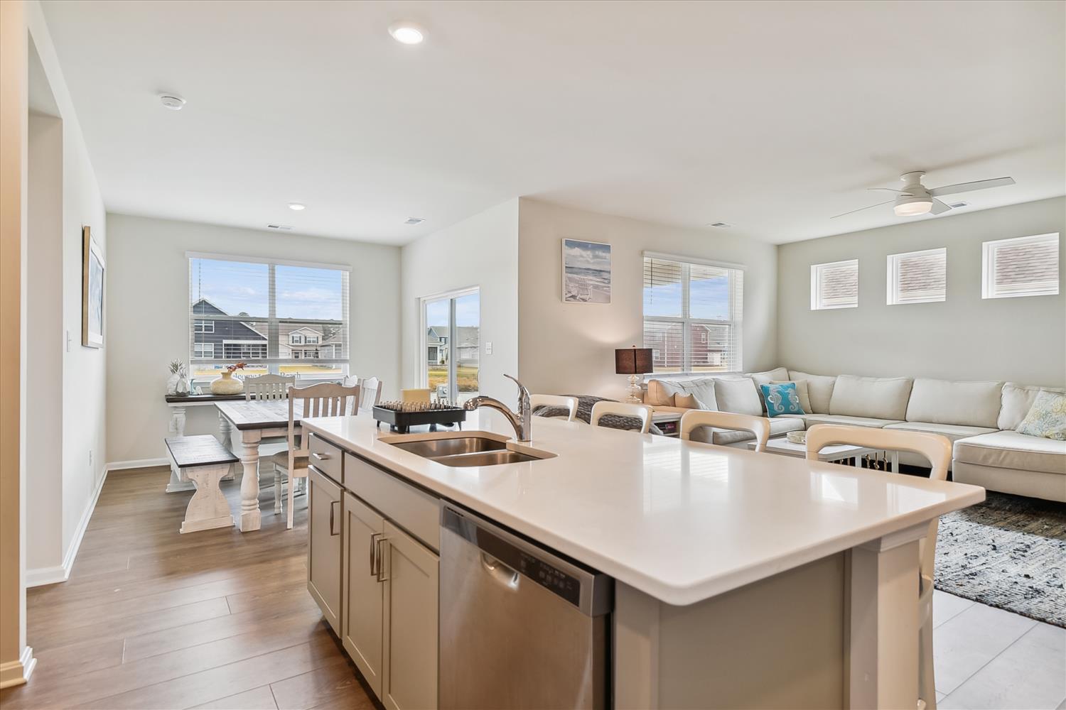 Gather around your spacious kitchen island, where bright natural light and modern finishes create the perfect space for meal prep and conversation. The open layout flows seamlessly into your cozy dining nook and inviting living area.