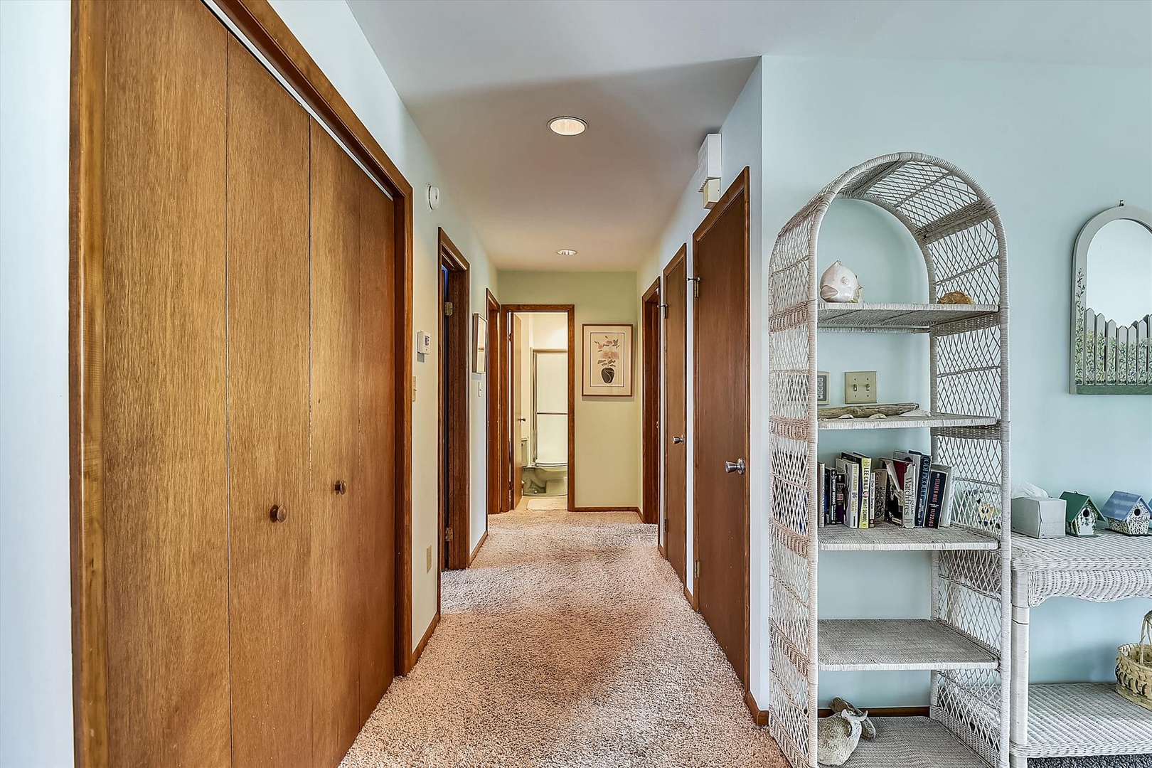 A bright hallway with warm wood accents and convenient storage, leading you effortlessly to your private spaces and modern bathroom.