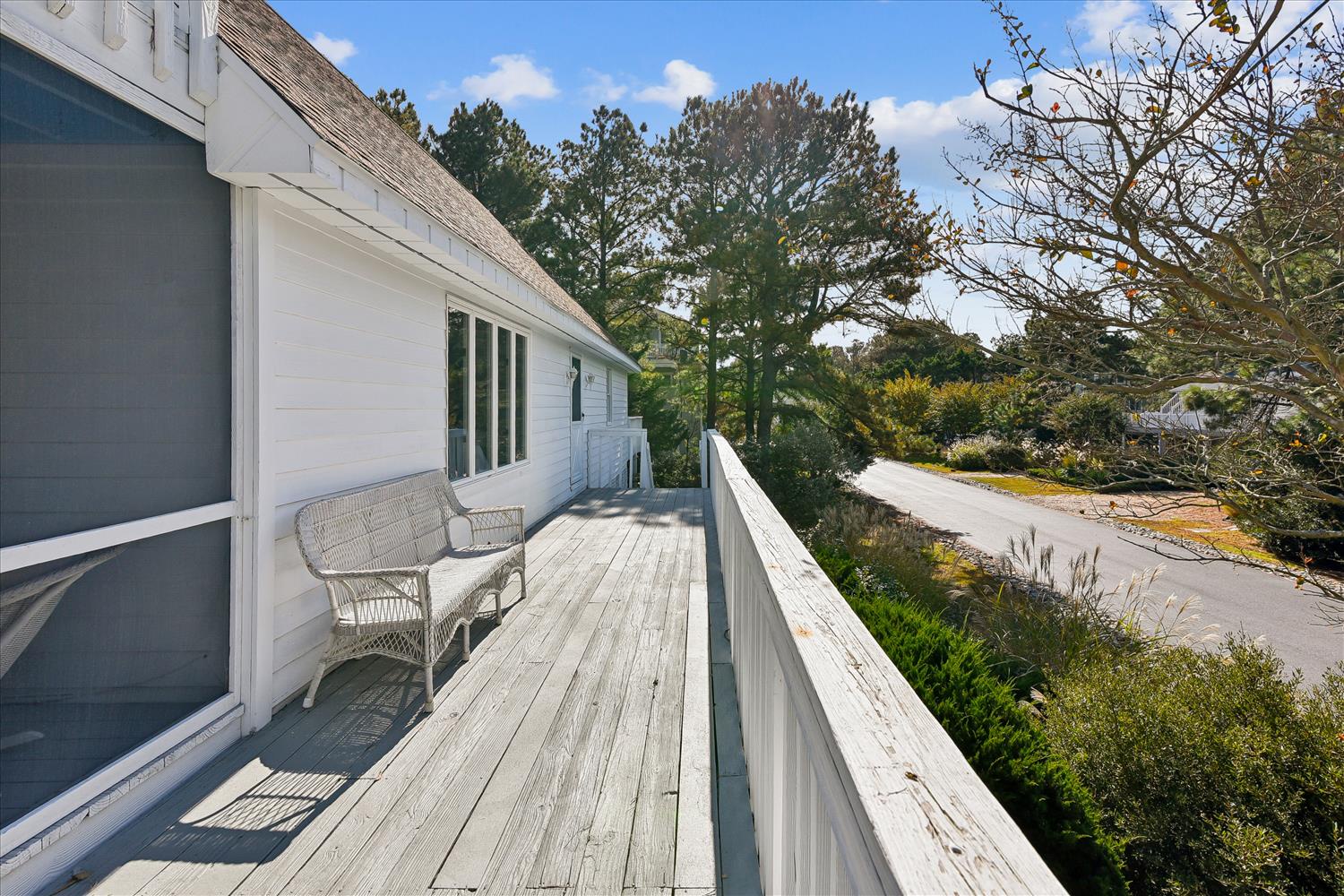 Step onto your private deck where wicker seating invites peaceful mornings with coffee while mature trees provide natural tranquility.