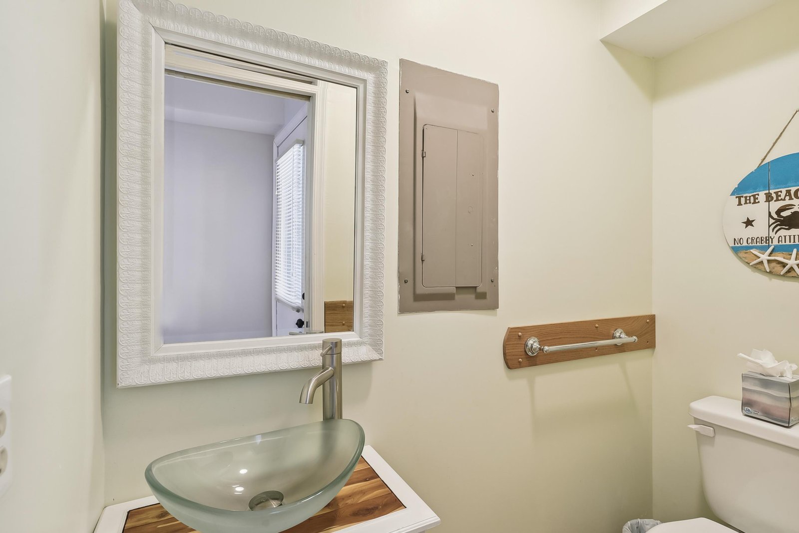 Freshen up in your coastal-inspired bathroom with its stylish glass vessel sink and beachy charm.