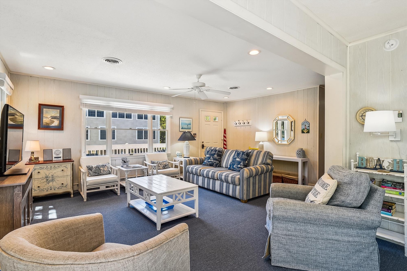 Sink into the coastal-inspired comfort of your living room, where nautical decor and plush seating invite you to unwind after a day of seaside adventures.