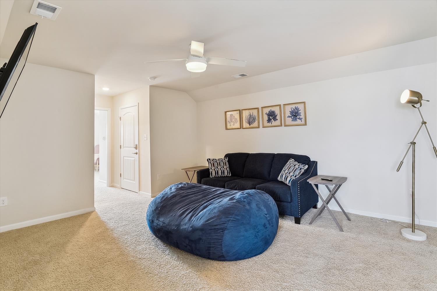 Sink into the plush navy bean bag or stretch out on the cozy sofa in your private living space.