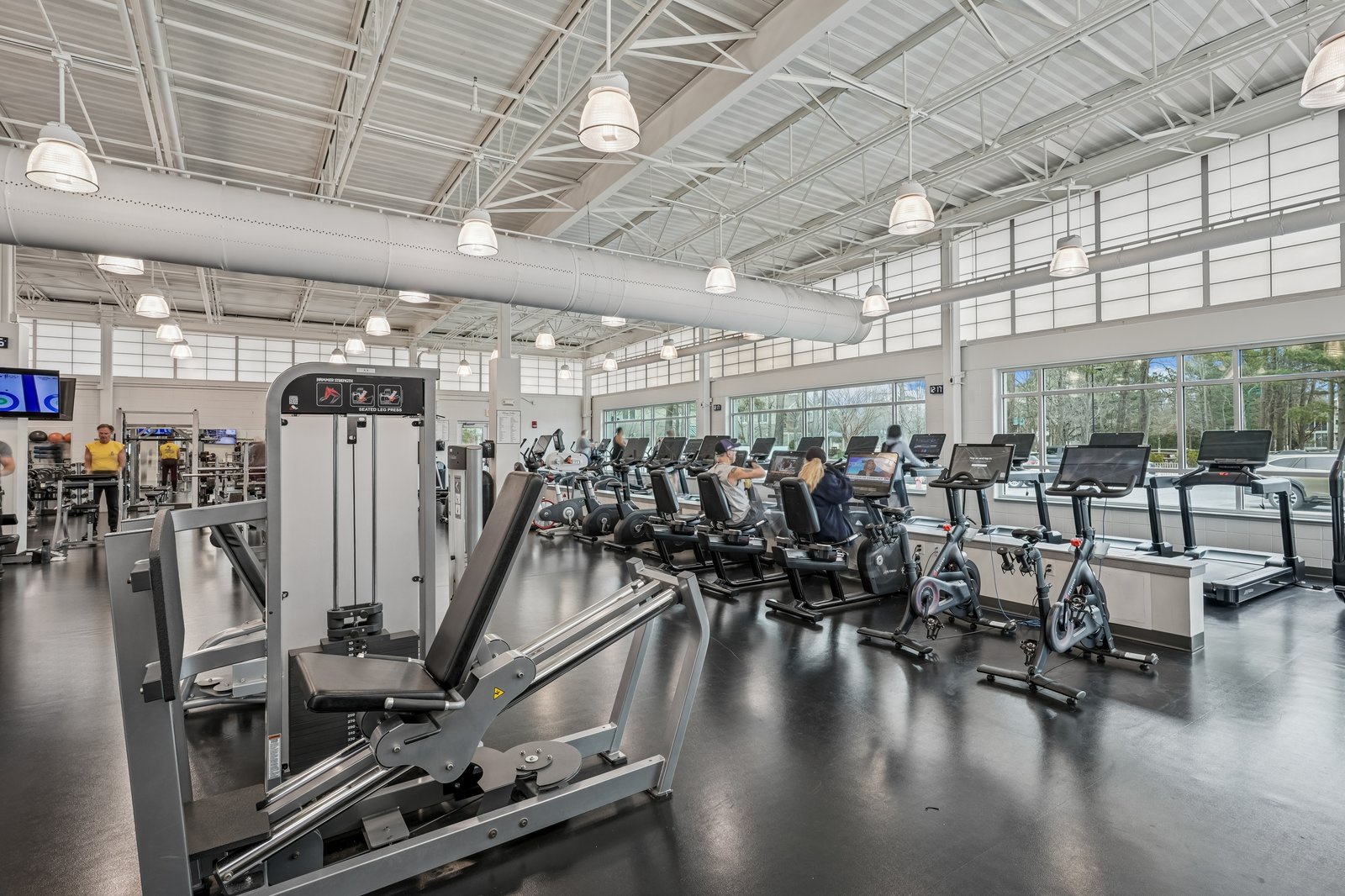 Stay active in this modern fitness center with cardio equipment, weight machines, and natural light.