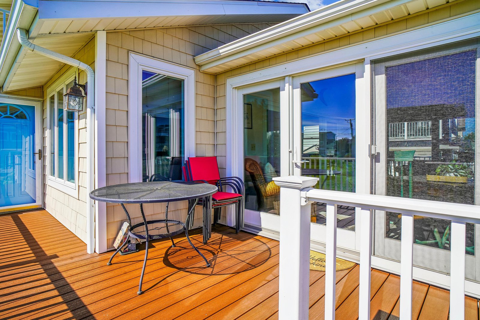 Step onto your private deck where crisp coastal air meets morning coffee at a cozy bistro table, perfect for planning your day's beach adventures.