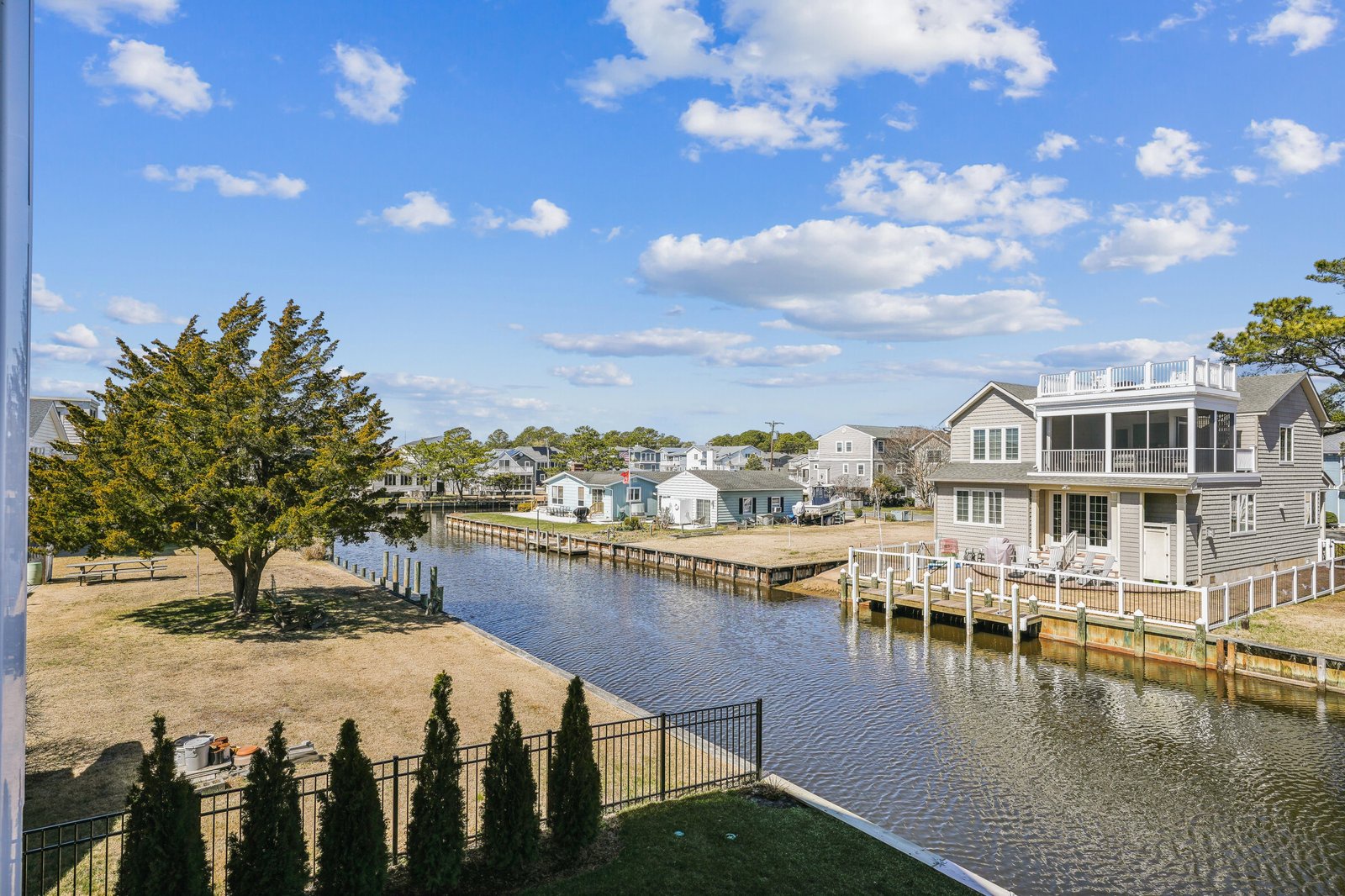 Waterfront community with private dock access, surrounded by coastal homes and natural beauty. Located in a peaceful neighborhood with canal views.