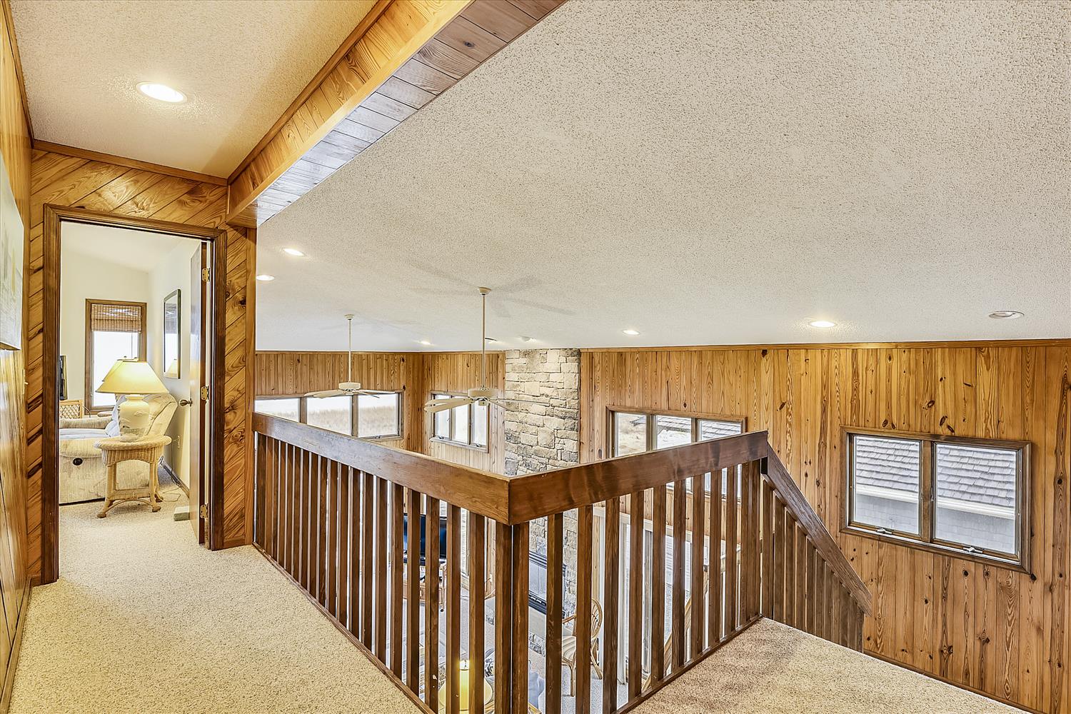 Warm wood paneling and vaulted ceilings create a cozy alpine retreat. The open loft design invites you to explore every corner of your mountain getaway.