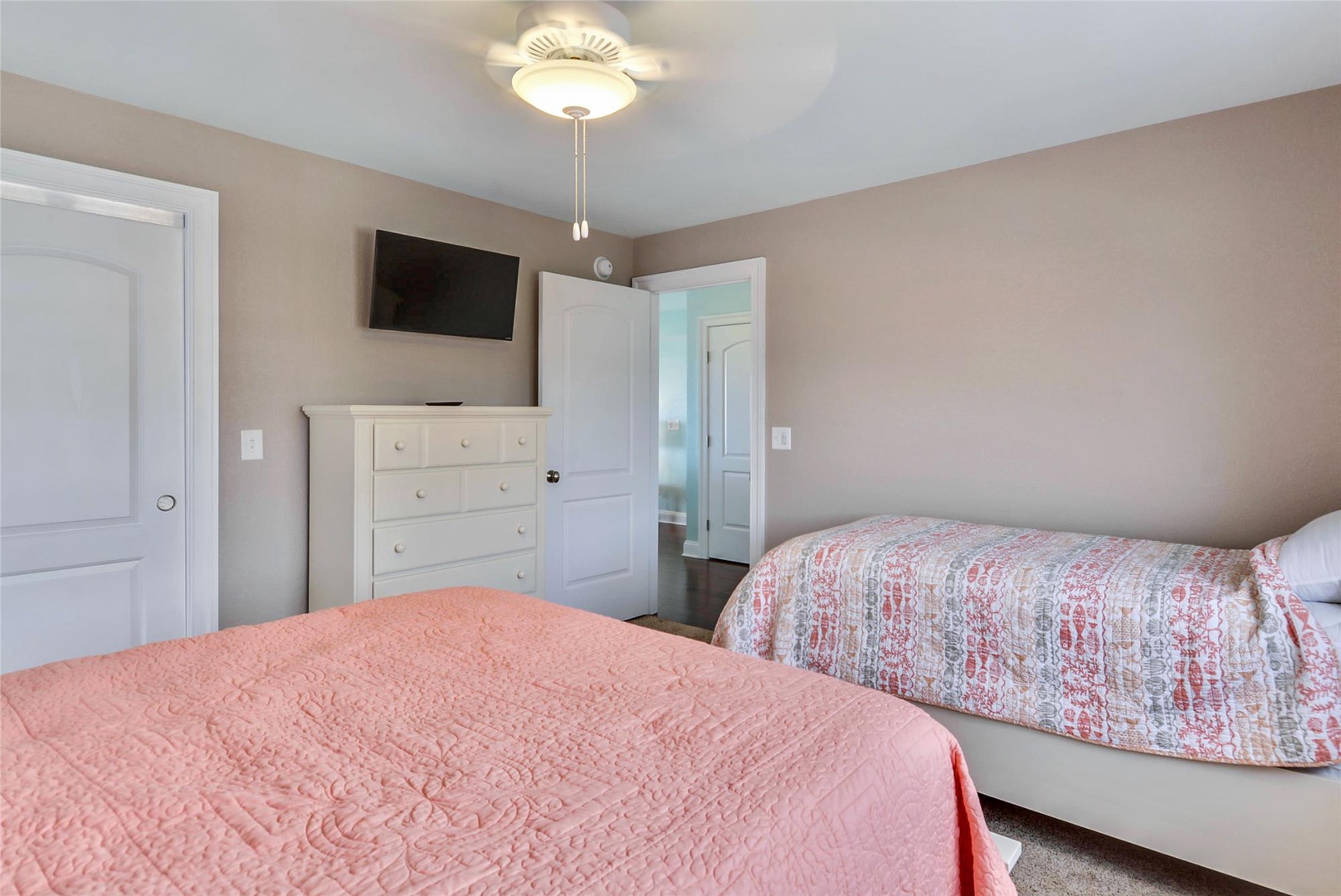 Unwind in your cozy bedroom with two comfortable beds, ample storage, and a mounted TV for your entertainment. A peaceful retreat awaits after a day of adventure.
