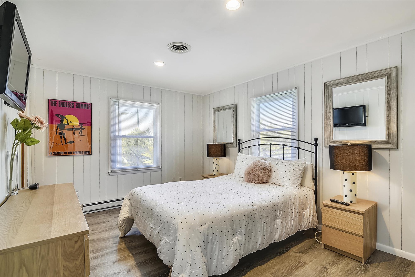 Sink into the plush bedding after your beach adventures. The crisp white walls and warm wood tones create a peaceful retreat, while natural light streams through dual windows.