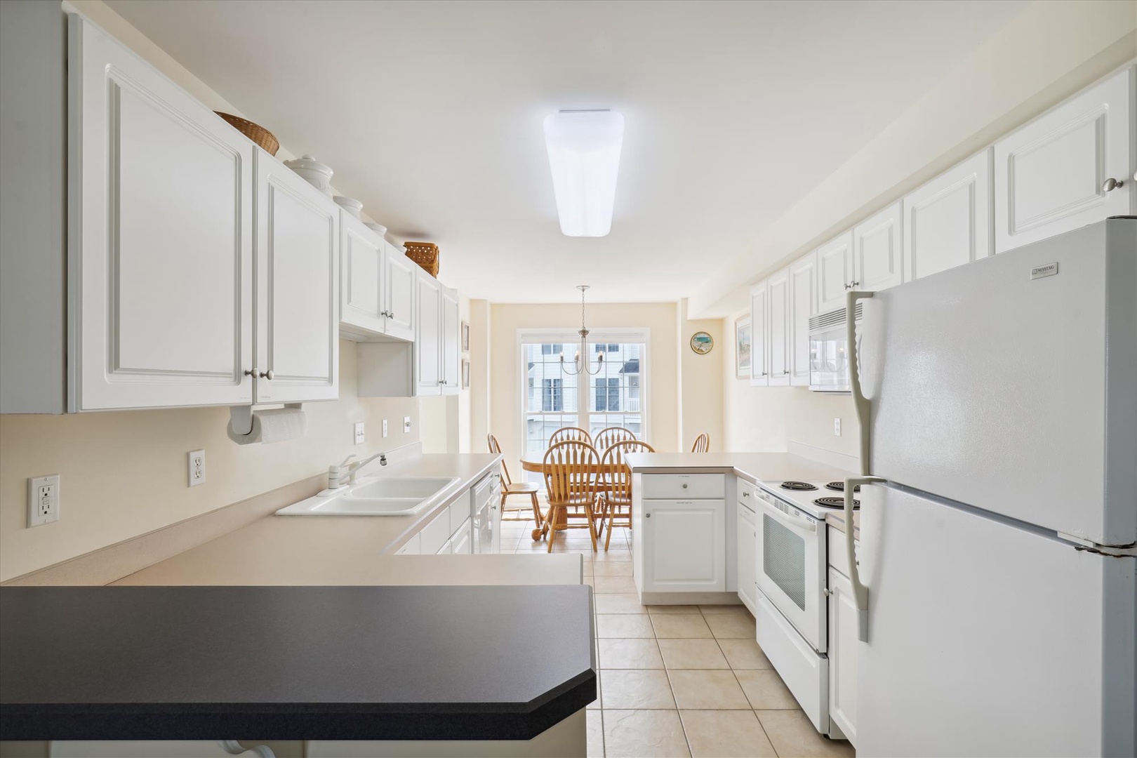Your bright, fully equipped kitchen features ample counter space and a cozy dining nook where you can enjoy home-cooked meals while natural light pours in through the windows.