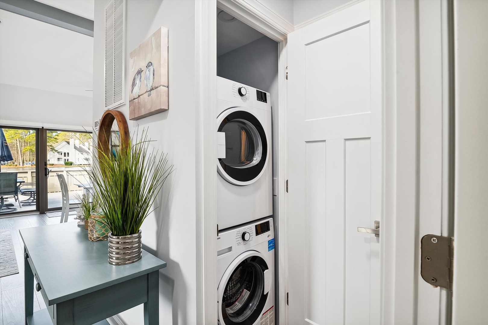 Your private laundry nook makes travel life easier with stacked washer and dryer tucked neatly in white cabinetry.