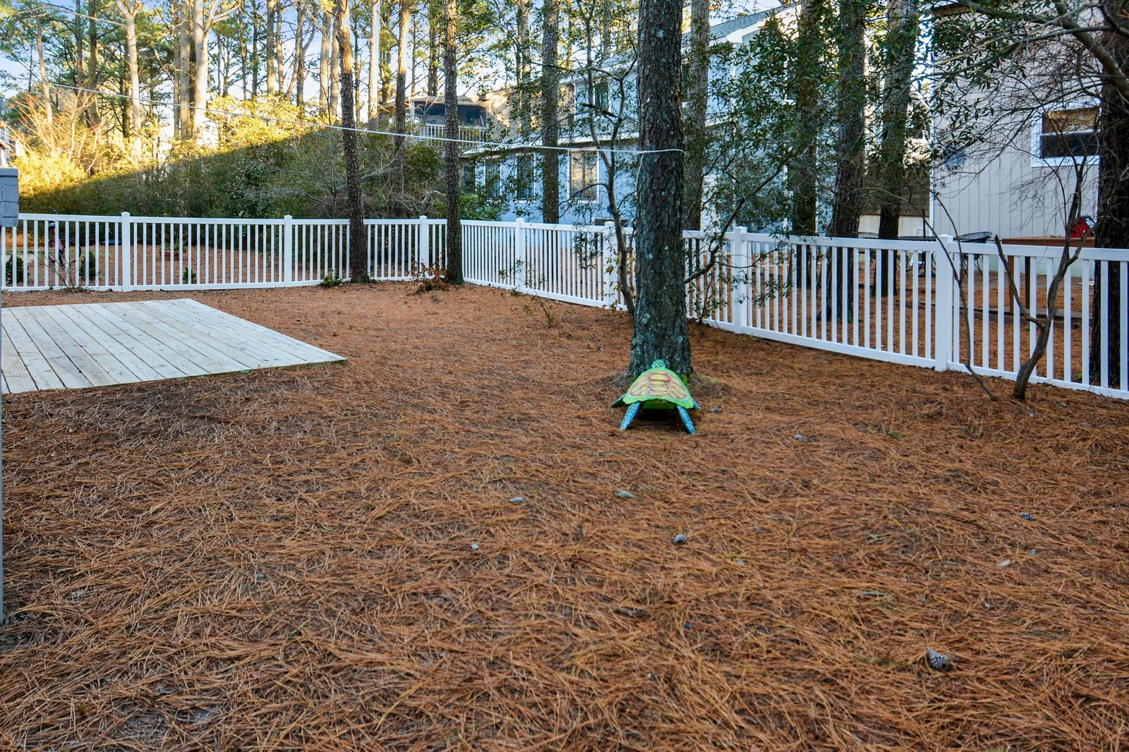A spacious fenced backyard offers privacy and room to roam, with mature trees providing natural shade for your outdoor enjoyment.