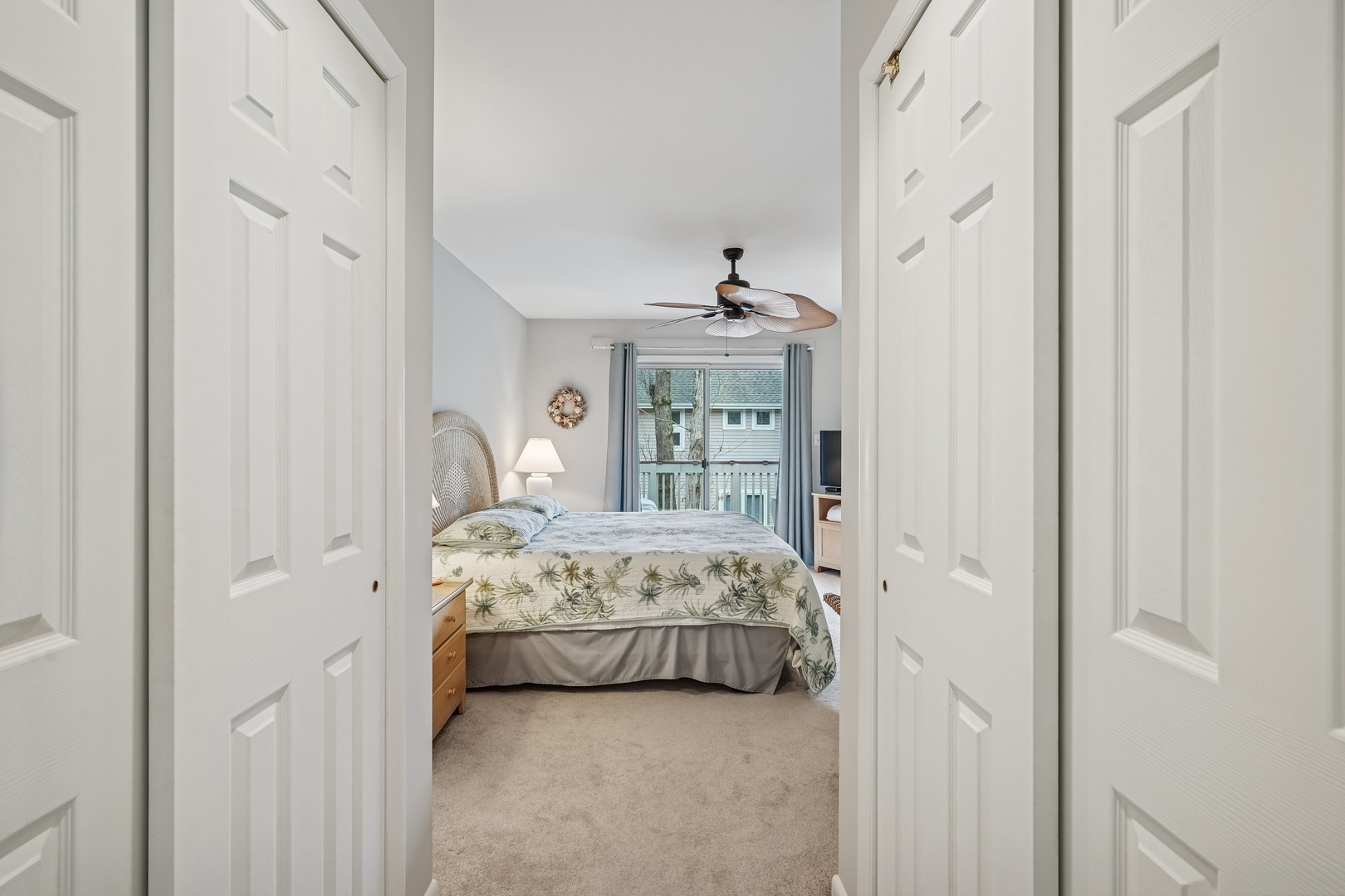 Step into your peaceful bedroom retreat with soft coastal bedding and gentle natural light streaming through windows.