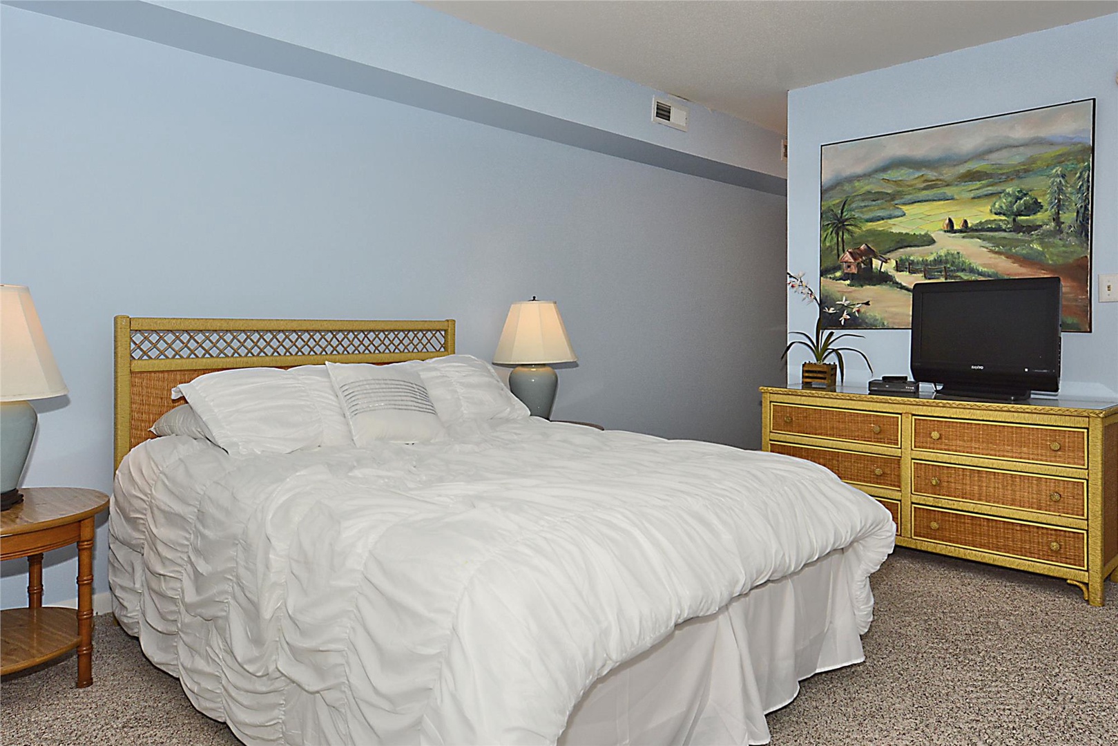 Sink into plush white bedding and unwind in your tranquil bedroom with tropical touches, a flat-screen TV, and soft ambient lighting for ultimate relaxation.