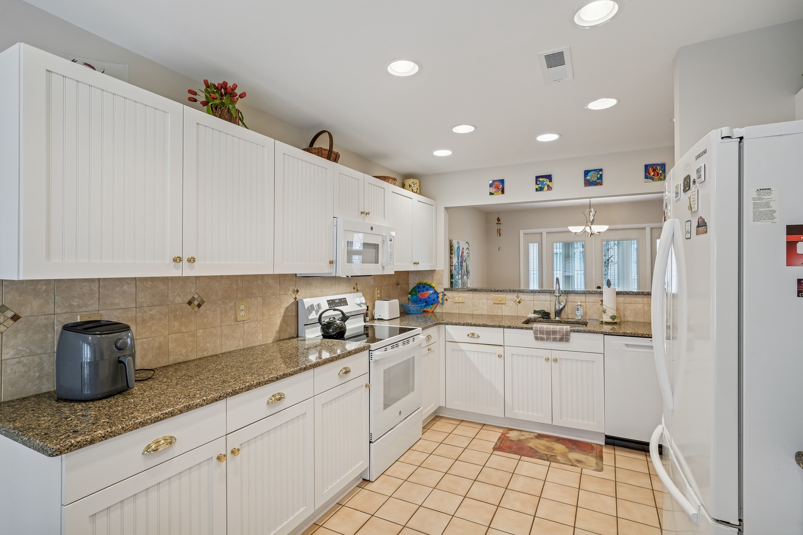 Cook your favorite meals in this bright, fully-equipped kitchen with granite counters and modern appliances.