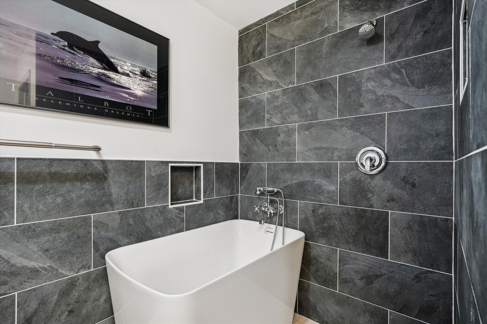 Slip into your deep soaking tub after a long day of exploring. Modern slate tile and a sleek rainfall shower create a spa-like retreat where you can truly unwind.