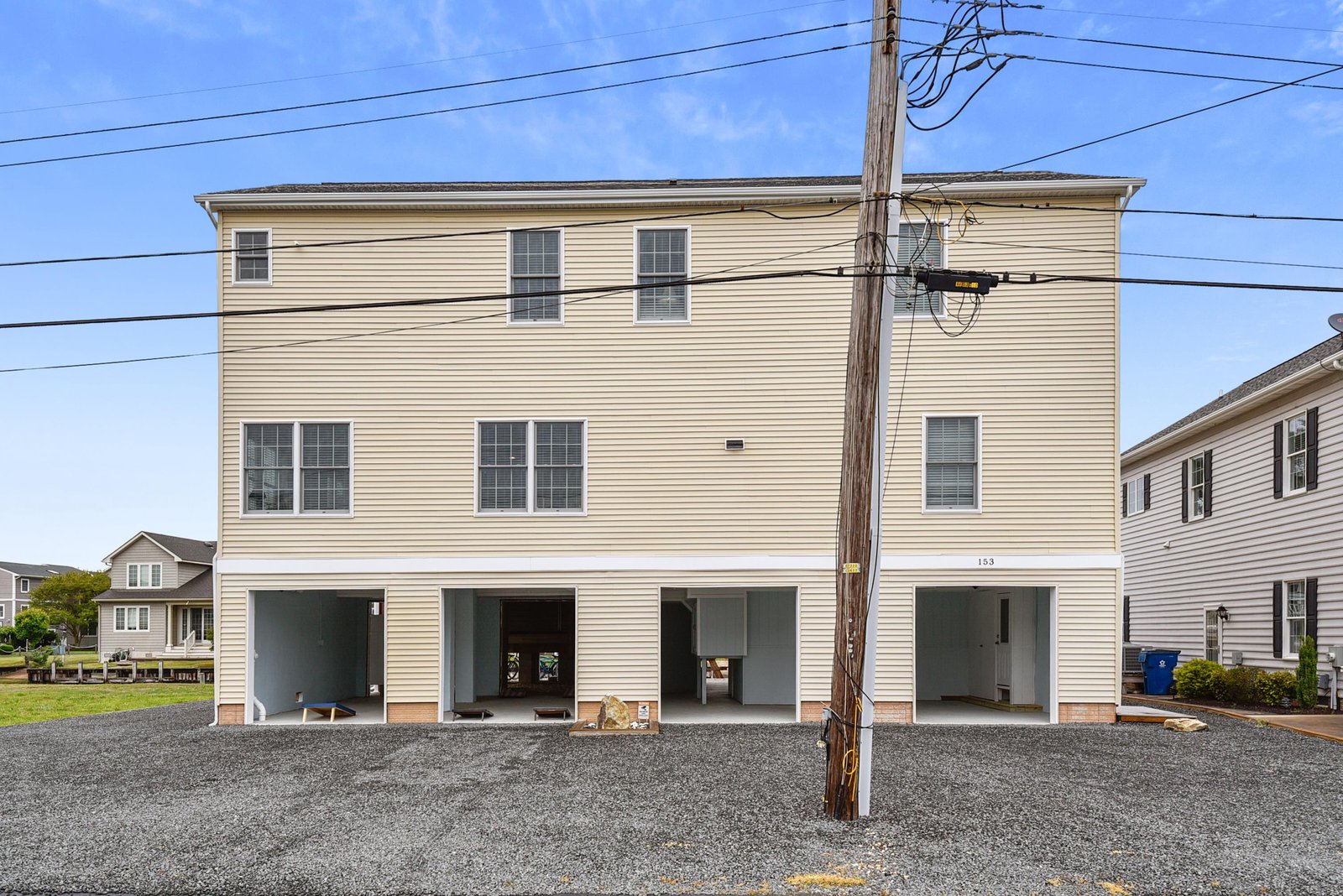 Two-story property in a quiet neighborhood with four ground-level parking spaces and nearby community conveniences.