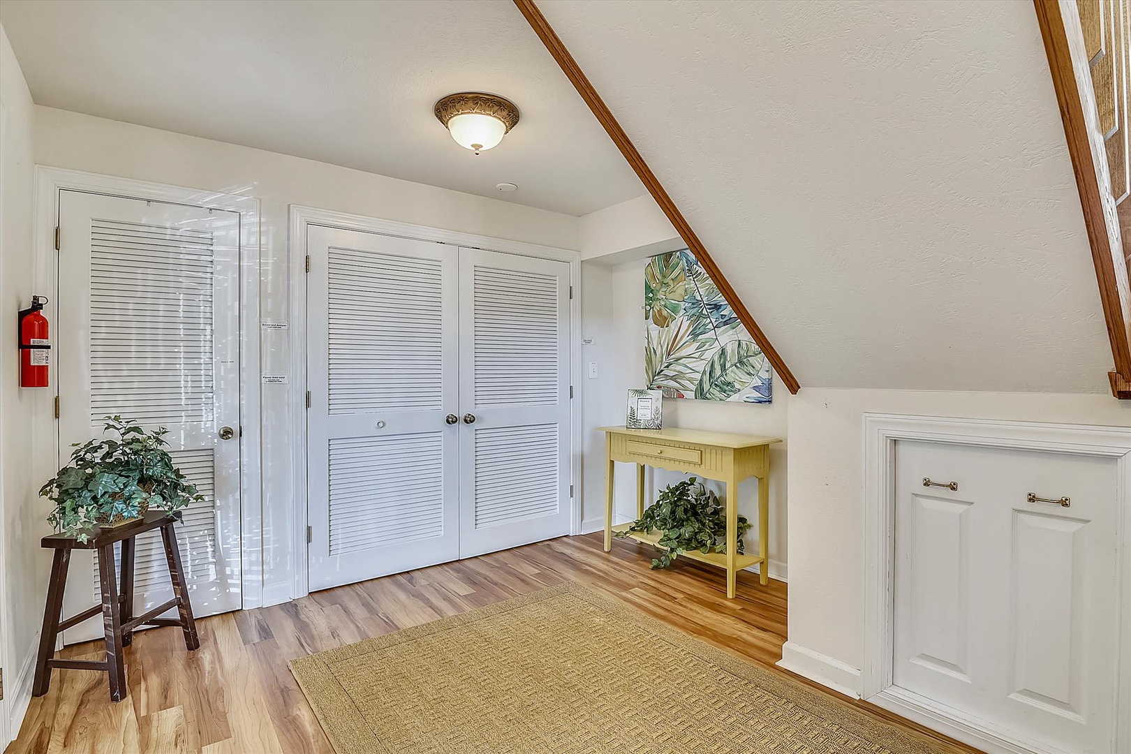 Your cozy living space features beautiful hardwood floors, ample storage with built-in cabinets, and charming sloped ceilings that create a welcoming retreat.