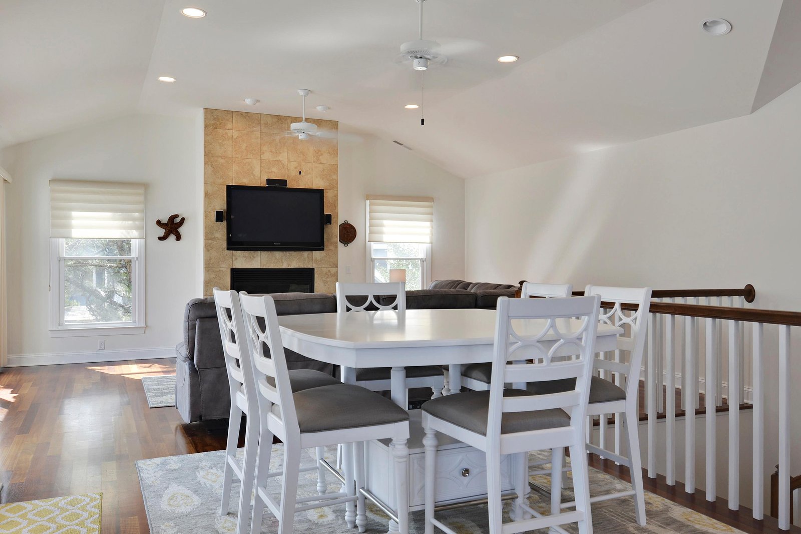 Gather around the welcoming dining table and relax into the bright, open-plan living area with cozy seating and a modern fireplace—your perfect home base for memorable vacation moments.
