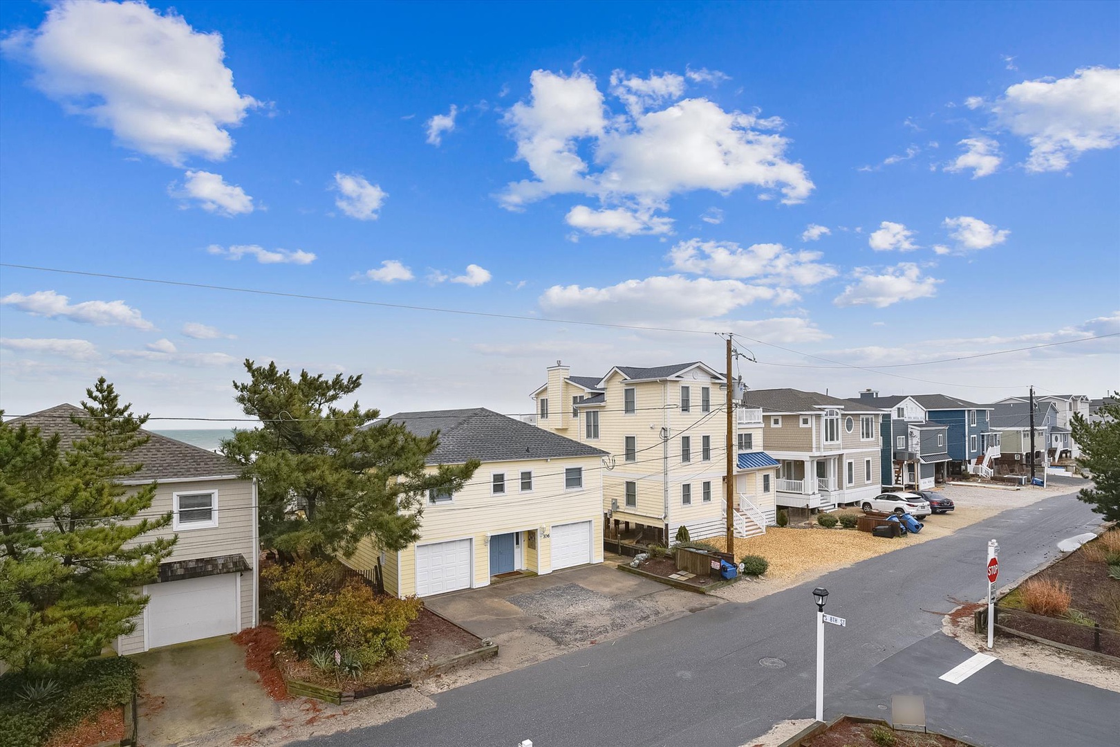 A peaceful coastal neighborhood with beach-style homes nestled among trees, offering a quiet residential setting near the property.