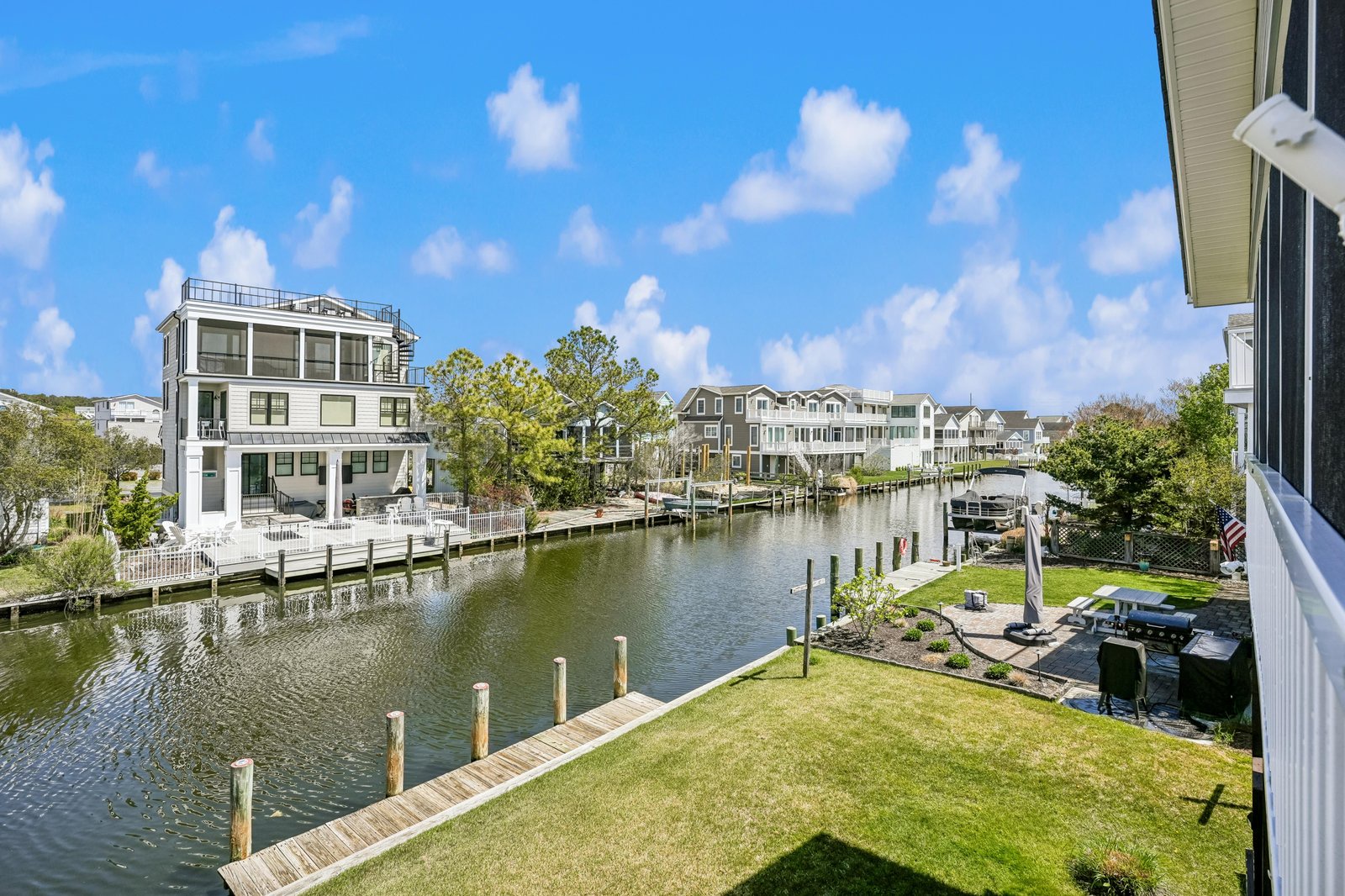 A tranquil waterfront property offering direct canal access, private dock, and manicured lawn surrounded by peaceful residential neighborhoods—perfect for boating enthusiasts and water lovers.