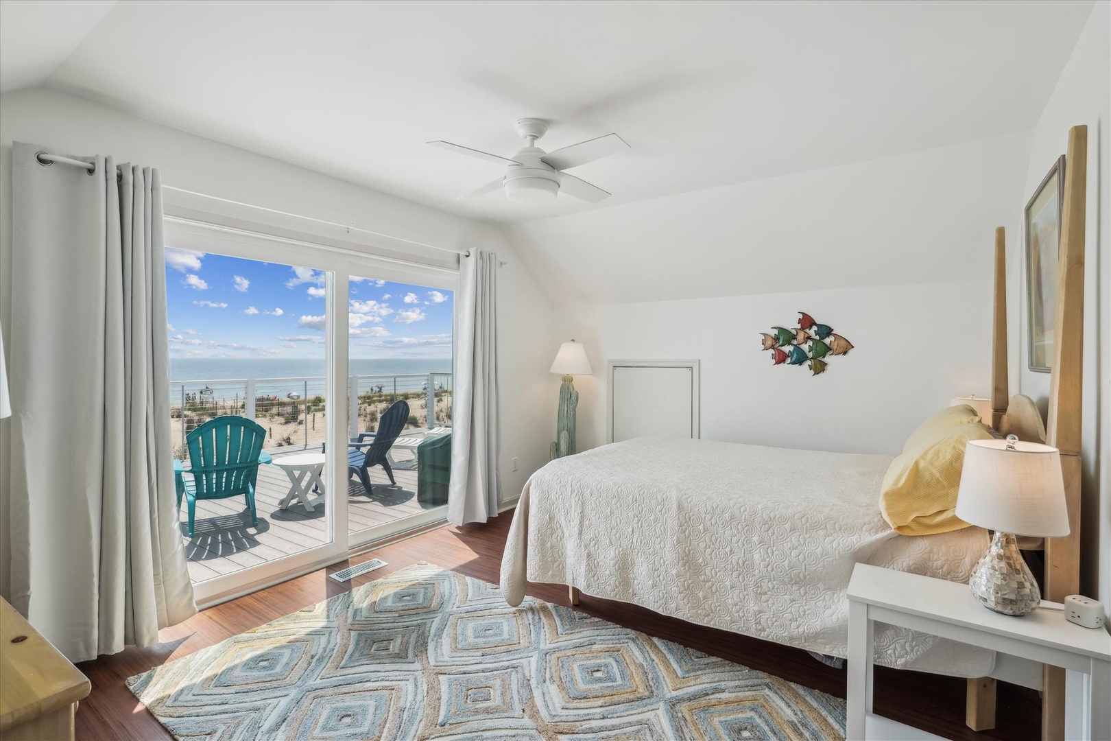 Drift off to the sound of waves in this coastal bedroom with stunning sea views from your private balcony—a peaceful retreat where ocean meets sky.