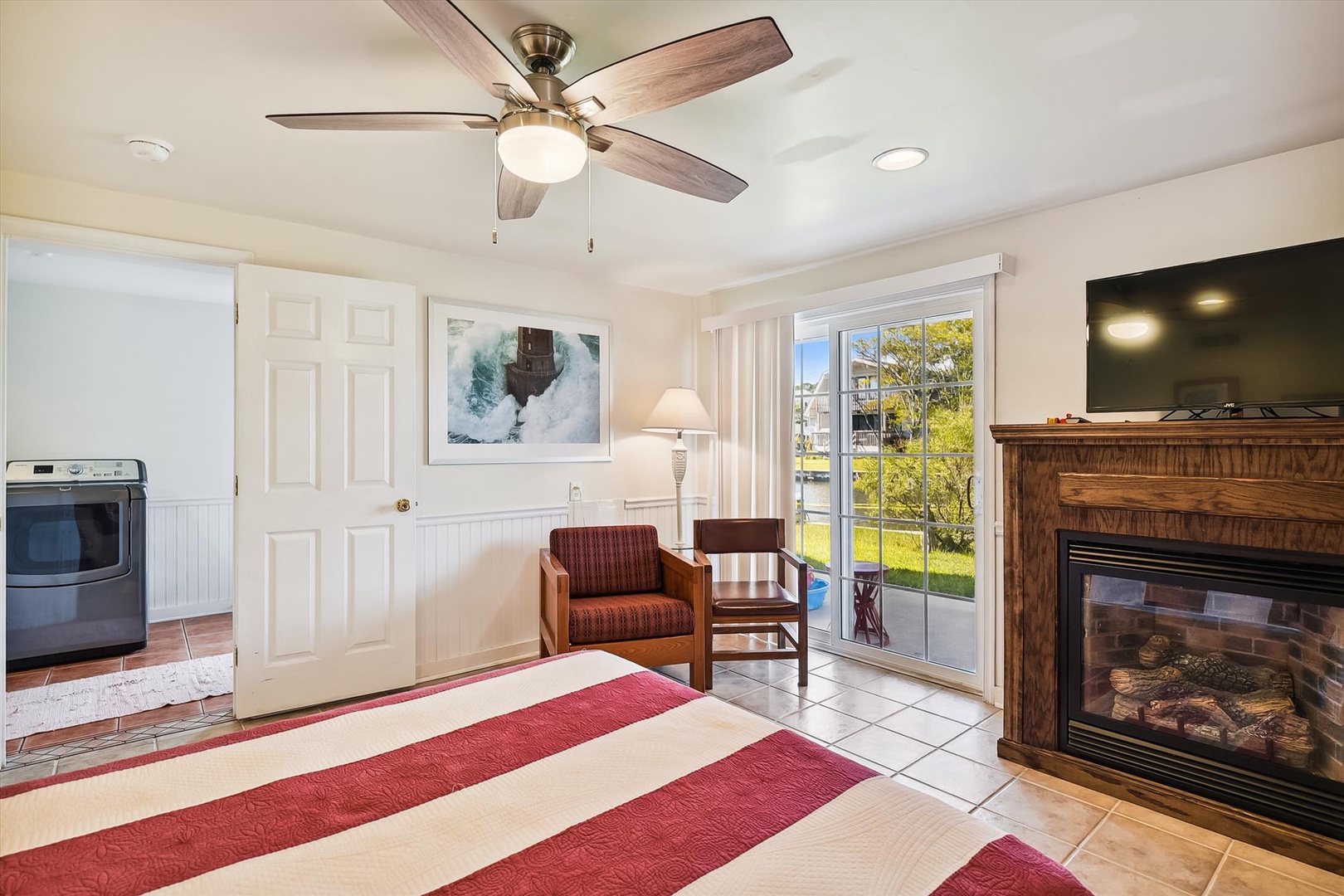 Step inside your bright, welcoming retreat where a cozy fireplace and ceiling fan keep you comfortable year-round, while sliding doors open to peaceful garden views.