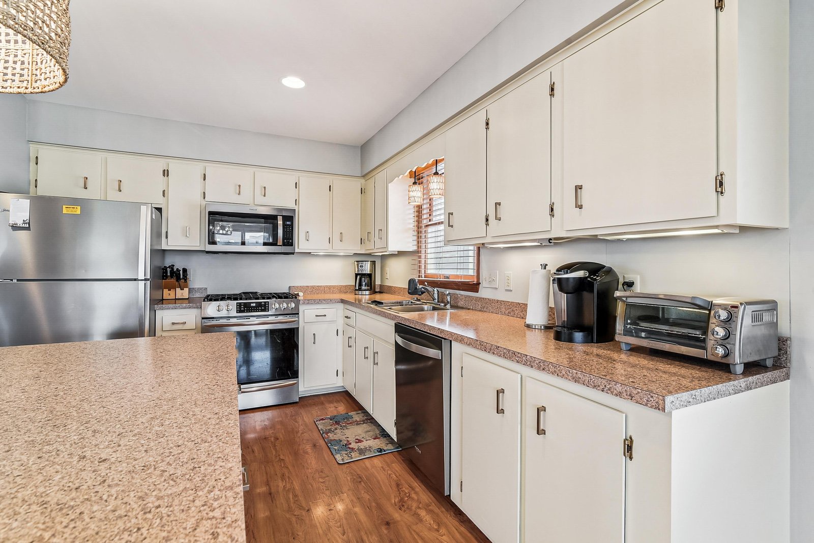 Cook your favorite meals in this bright, fully equipped kitchen with stainless appliances and generous counter space, perfect for your home-away-from-home stay.