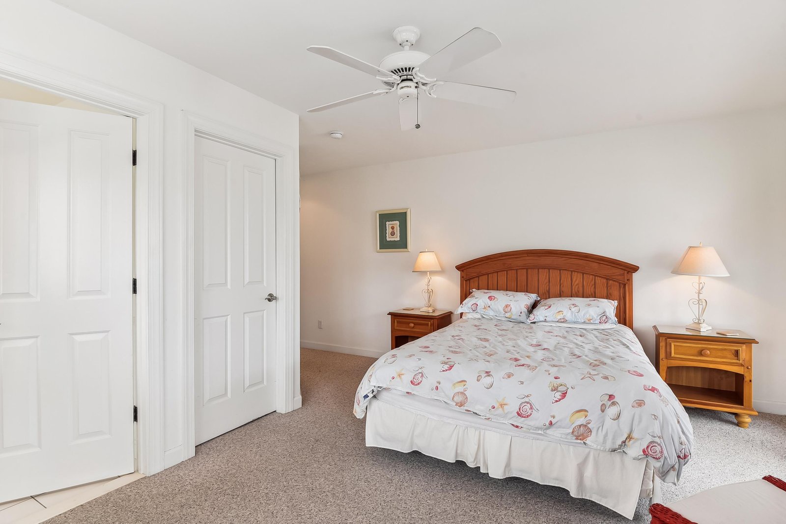 Step into your peaceful bedroom retreat with warm wood furnishings, soft lighting, and a ceiling fan to keep you comfortable all night long.