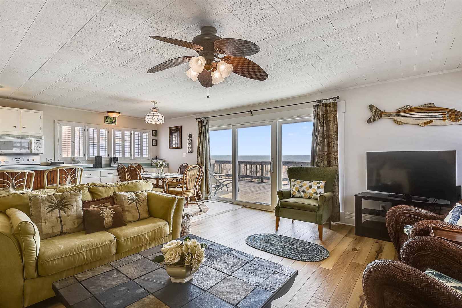 Sink into the coastal-inspired living space where ocean breezes meet laid-back comfort. Your waterfront escape awaits through sliding glass doors opening to panoramic views.