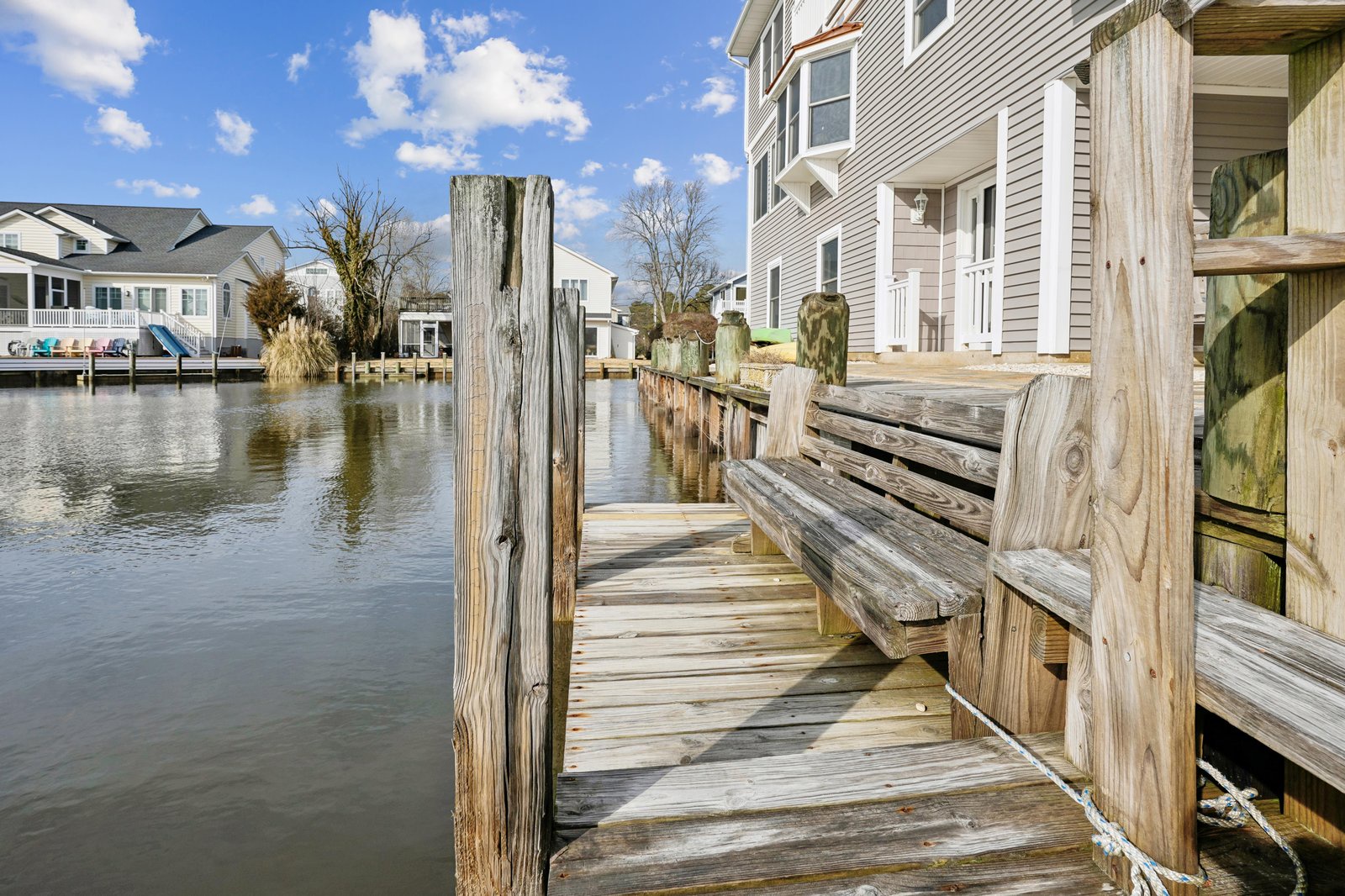 Private waterfront dock perfect for mooring boats and enjoying tranquil canal views in a peaceful residential neighborhood.