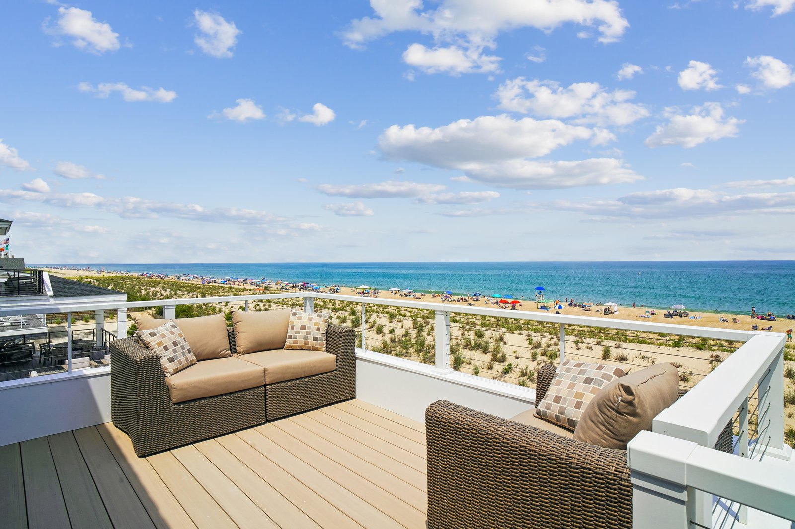 The property sits steps from a sandy beach where the ocean meets the shore, offering easy access to coastal relaxation and seaside activities.