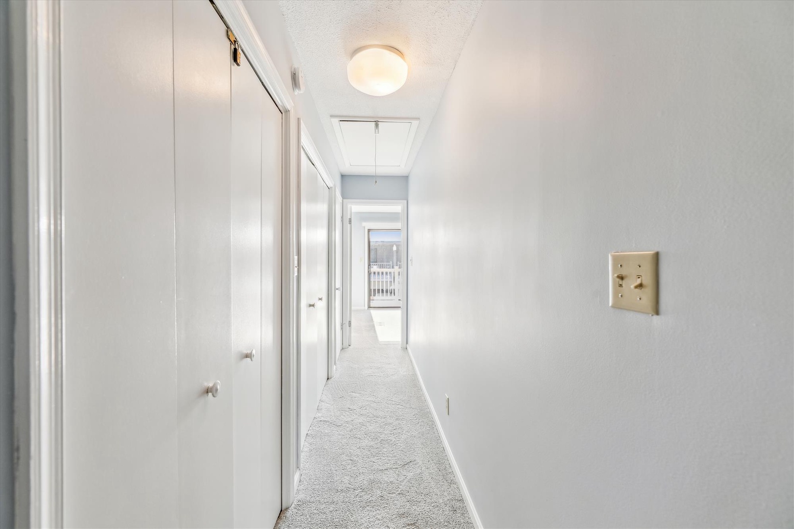 A bright, clean hallway leads you through the space, connecting your private quarters with fresh carpeting underfoot and plenty of natural light drawing you in.