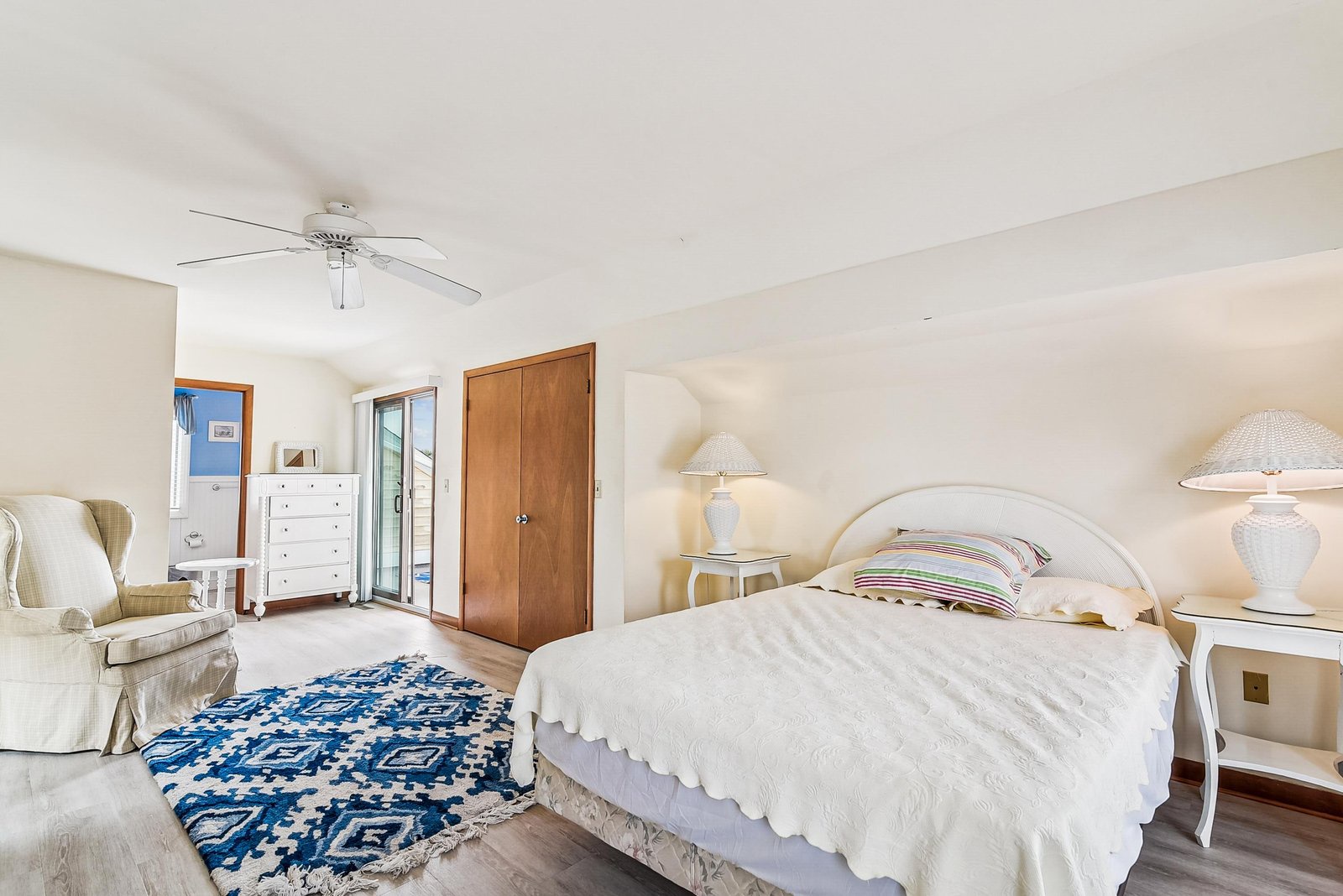 Unwind in your bright, airy bedroom where soft linens and gentle ceiling fan breezes promise restful nights and peaceful mornings.