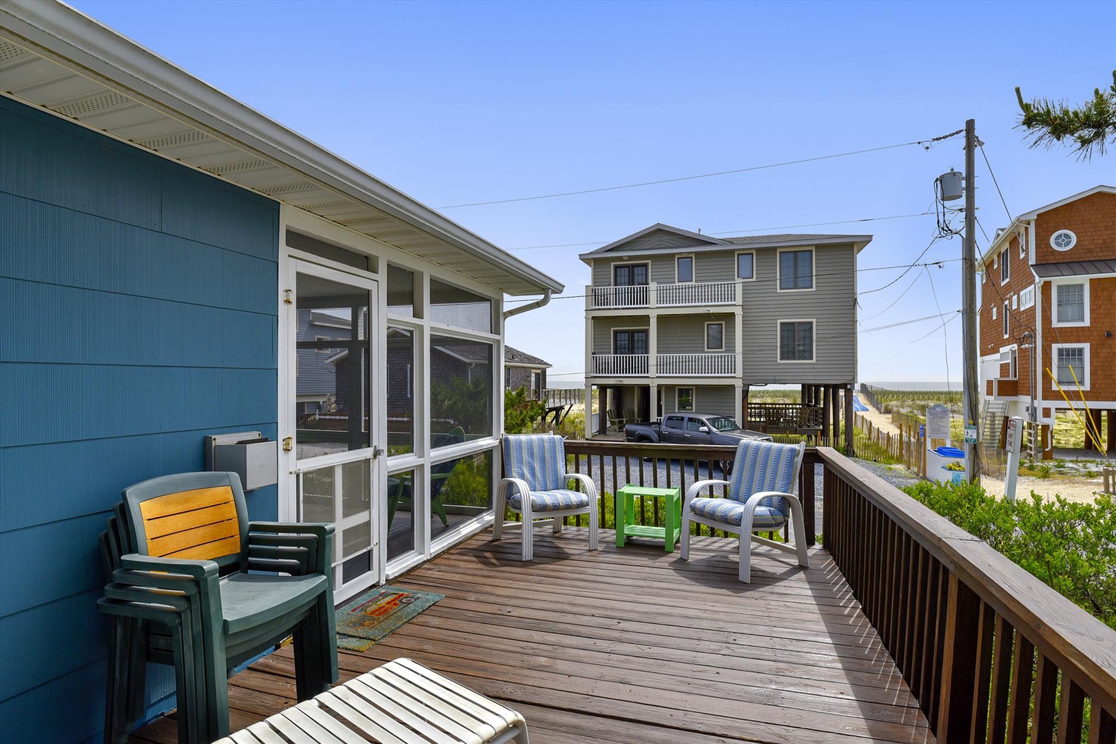 Settle into your private deck with comfortable seating and coastal breezes, where sunny afternoons and serene water views create the perfect backdrop for your beach getaway.