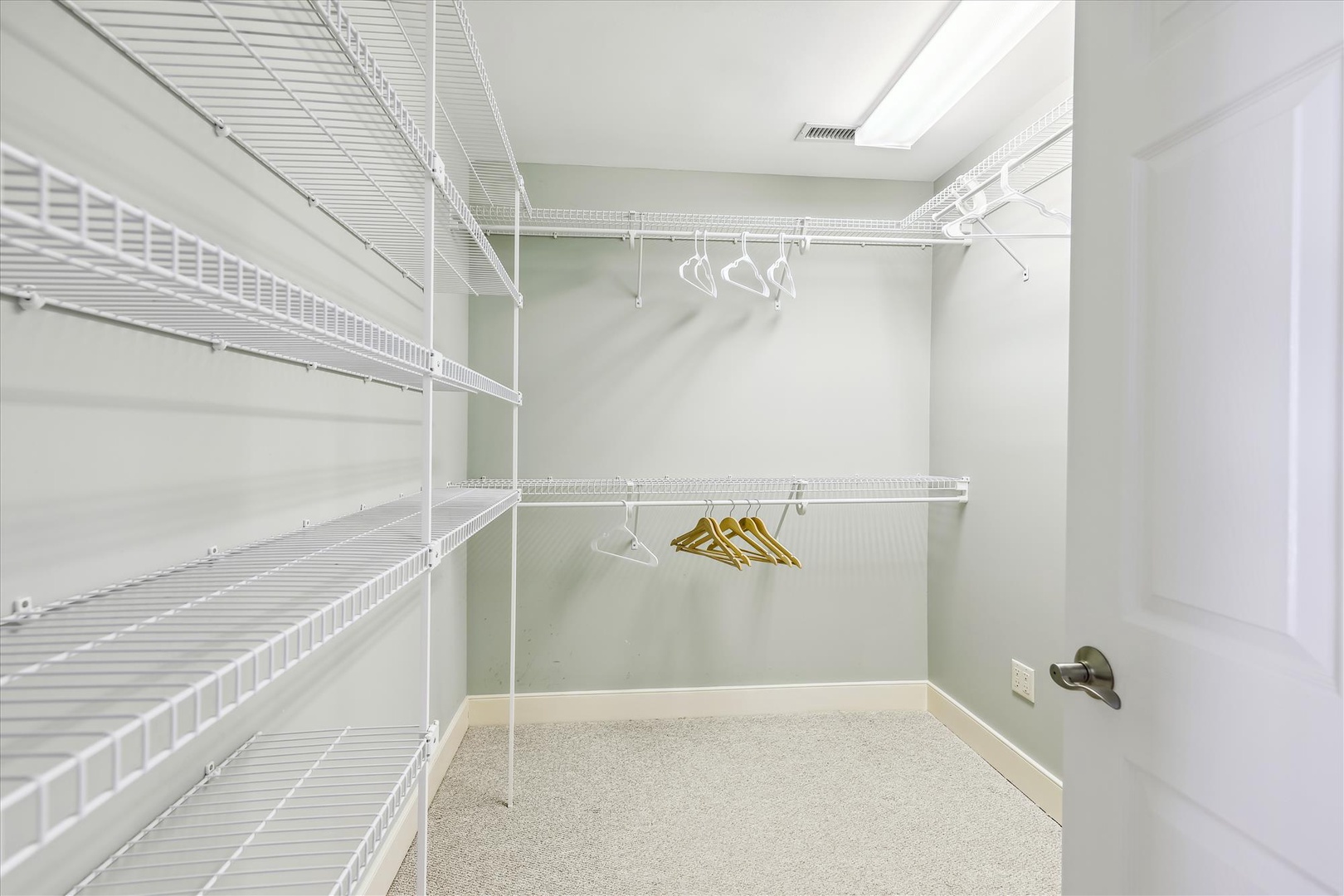 Generous walk-in closet with ample shelving and dual hanging rods to keep your wardrobe organized and within easy reach throughout your stay.
