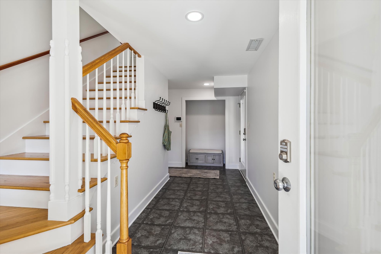 A welcoming entry with plenty of space to settle in. Durable tiled floors and a handy bench make arrivals and departures effortless.