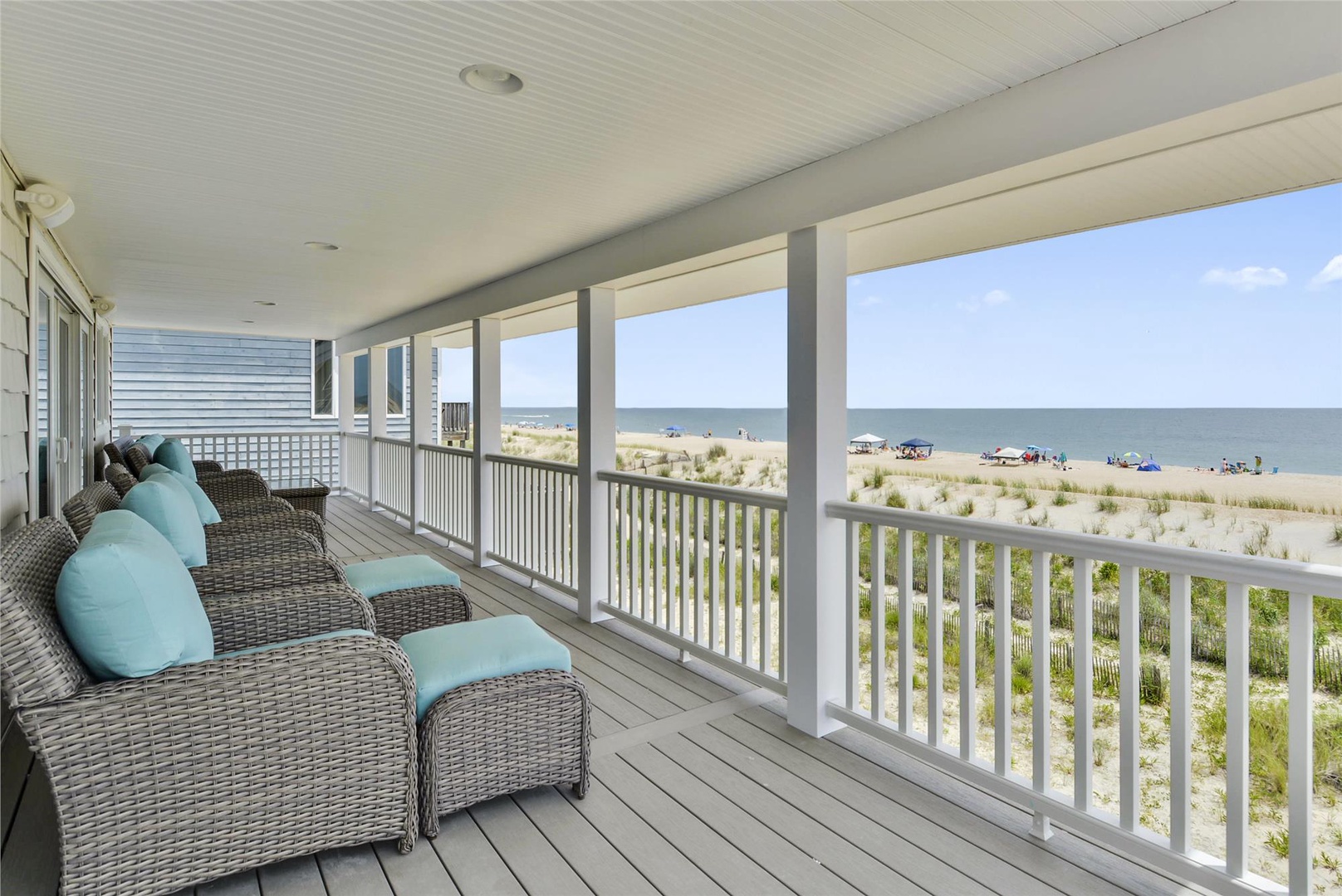 Sink into the plush wicker lounge chairs on your private balcony and soak in stunning oceanfront views—your beachside retreat awaits just steps from the sand.