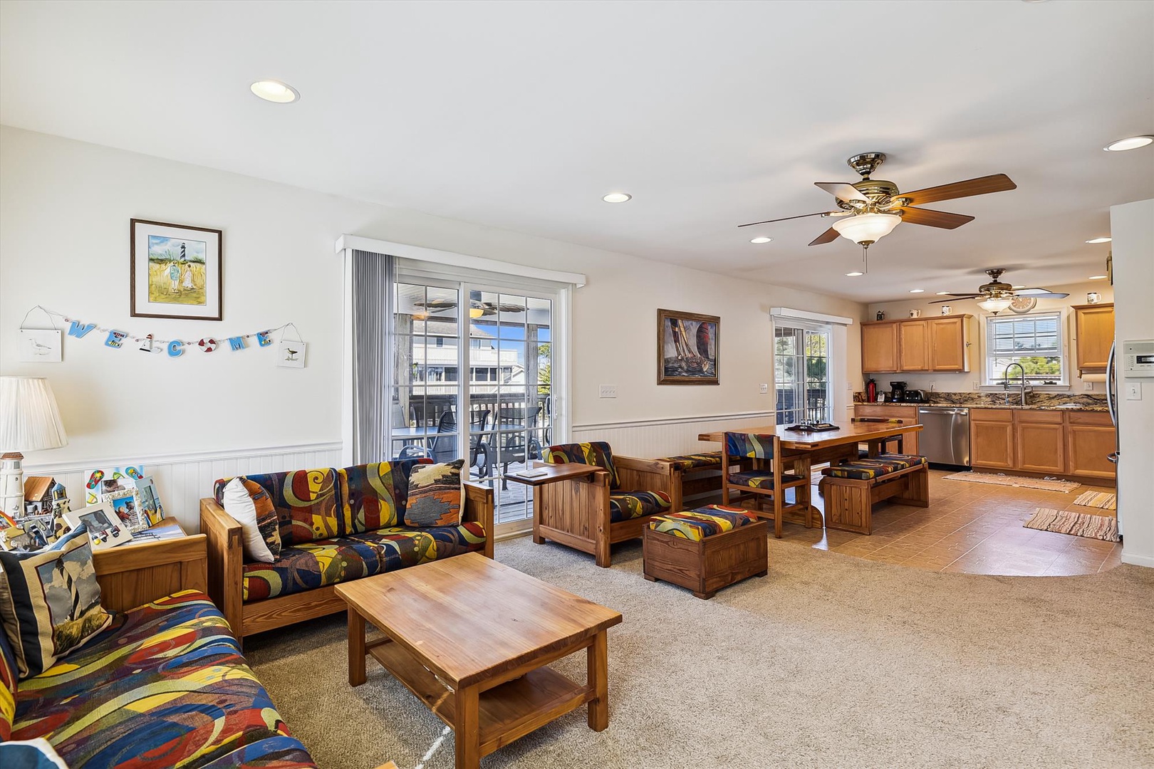 Sink into comfortable seating in this bright, open living space where coastal charm meets homey comfort, perfect for unwinding after your beach adventures.