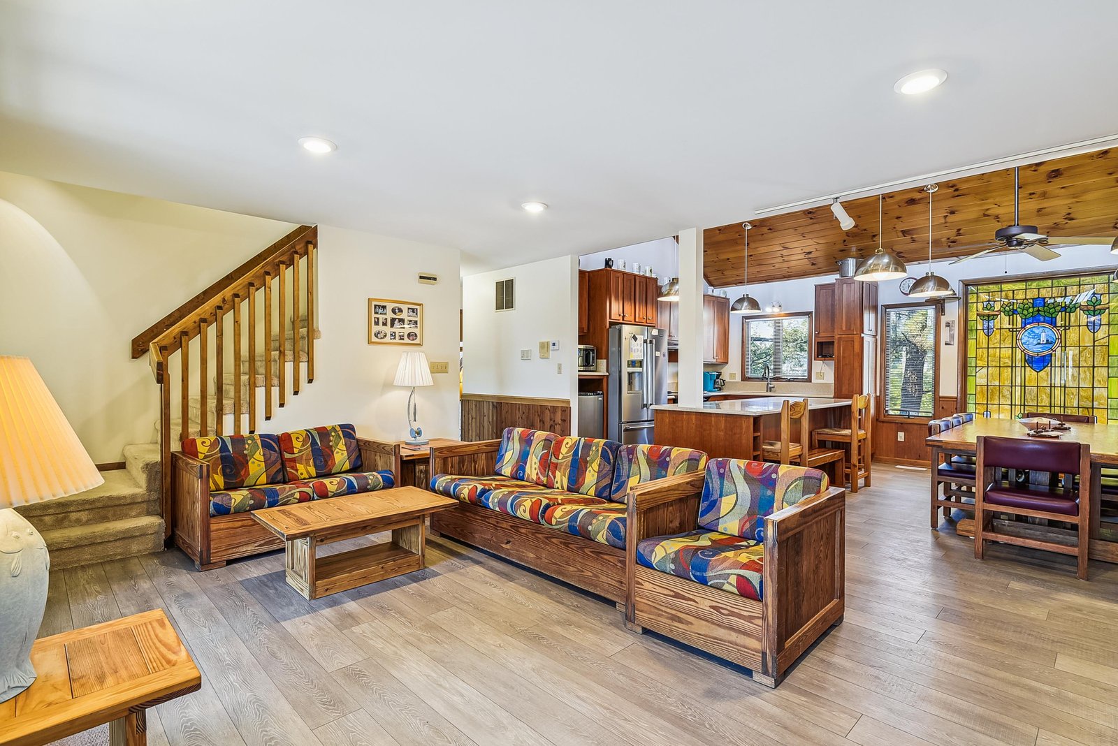 Settle into your spacious living area, where colorful seating and warm wood tones create a welcoming space to relax, gather with family, or plan your day's adventures.