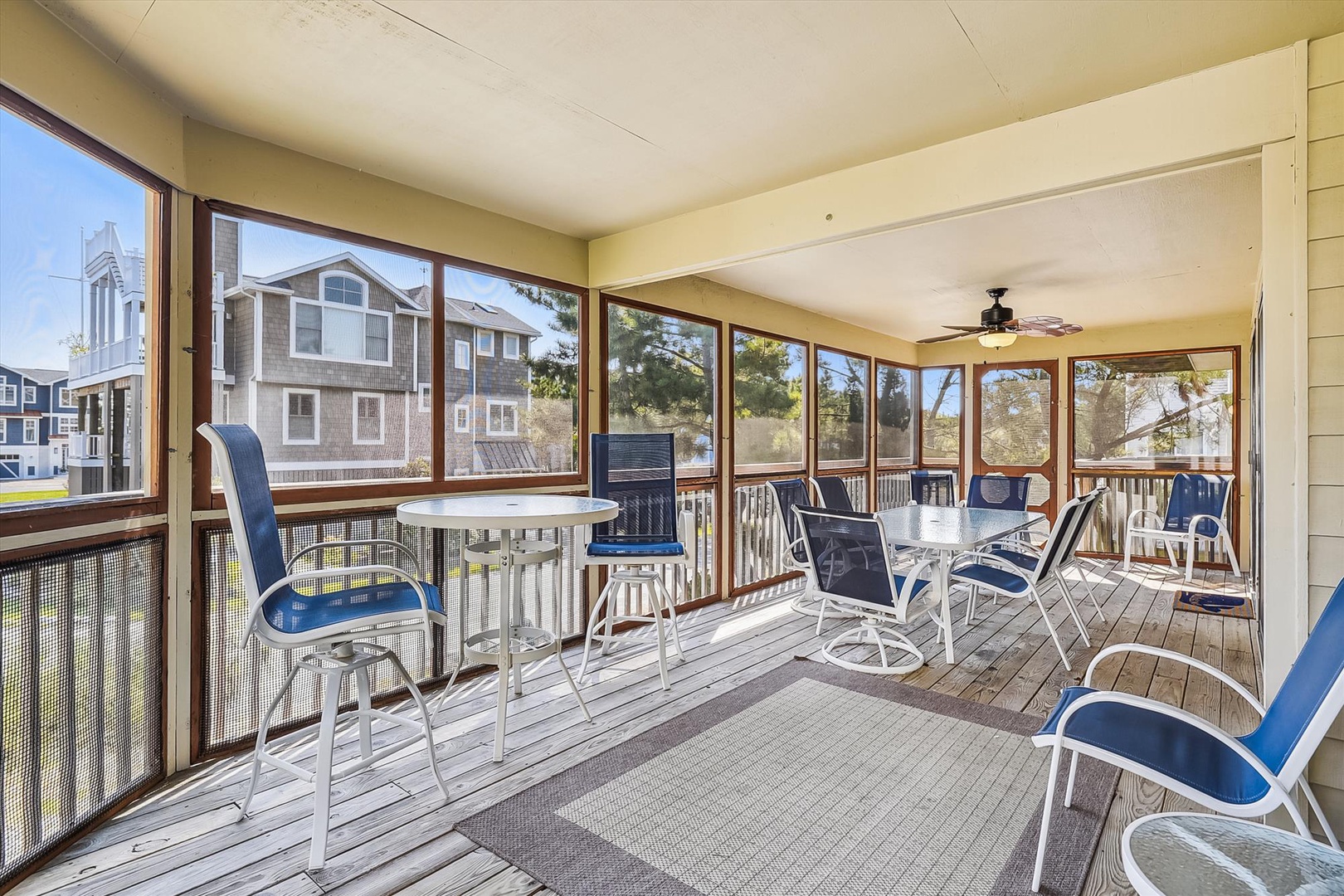 Picture yourself here on this spacious screened porch, sipping morning coffee at the high-top table or lounging in comfortable seating while gentle breezes drift through. Your perfect coastal retreat spot awaits.