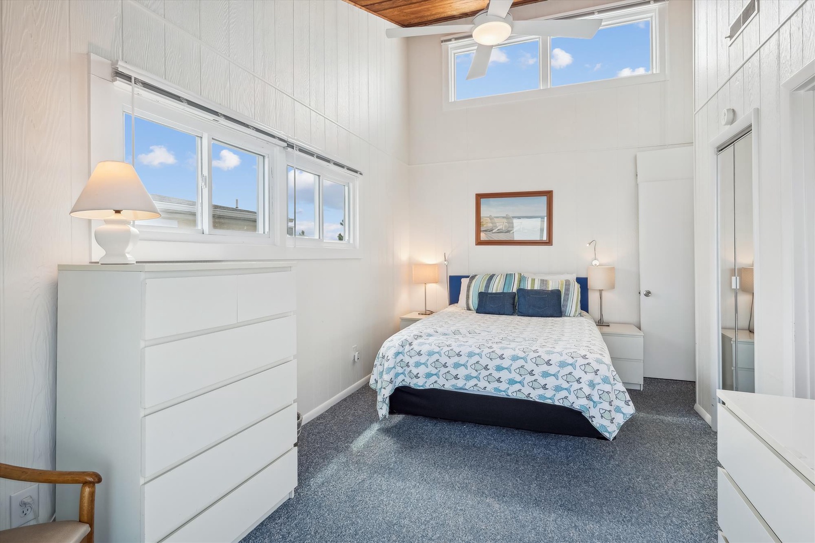 Relax in your bright bedroom with soaring ceilings and coastal charm. Plush linens, ample storage, and natural light create your peaceful retreat after beach adventures.