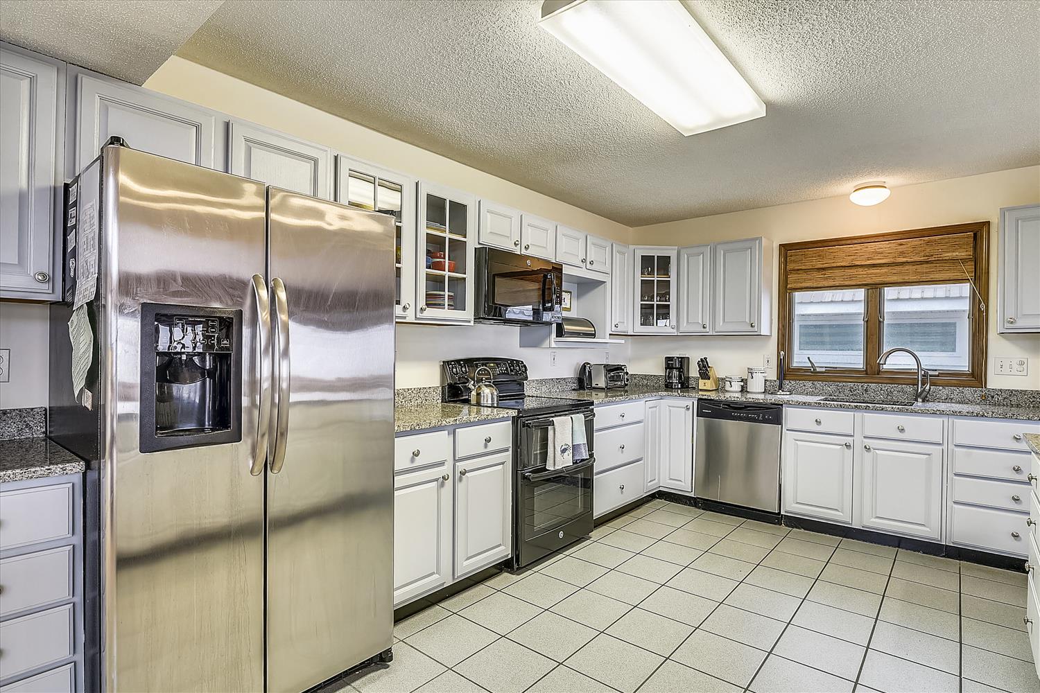 This bright, fully-equipped kitchen invites you to prepare your favorite meals with ease. Stainless appliances, granite countertops, and plenty of storage make cooking a pleasure during your stay.