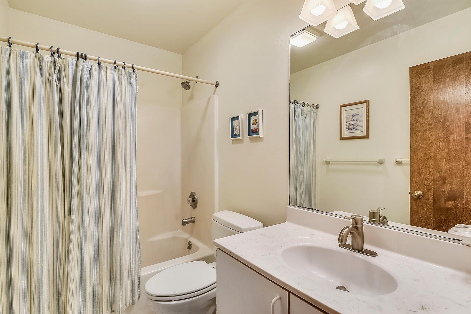 Clean, well-appointed bathroom with ample lighting and thoughtful touches to make your stay comfortable.