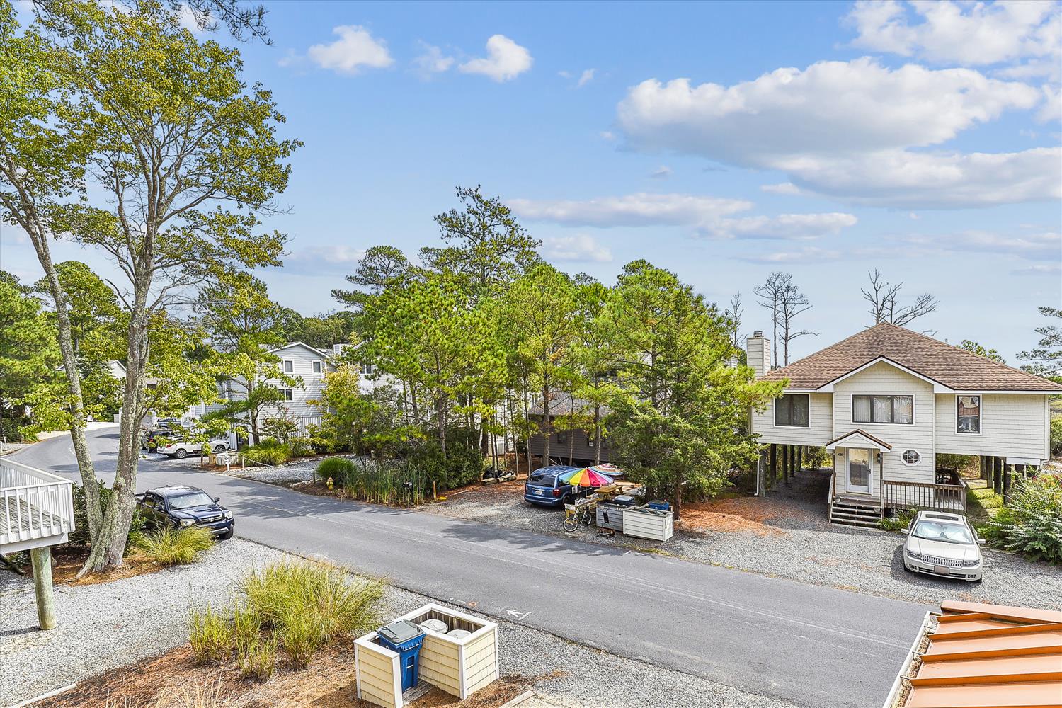 The property sits in a quiet residential neighborhood, surrounded by mature trees and offering convenient parking just steps from the entrance.
