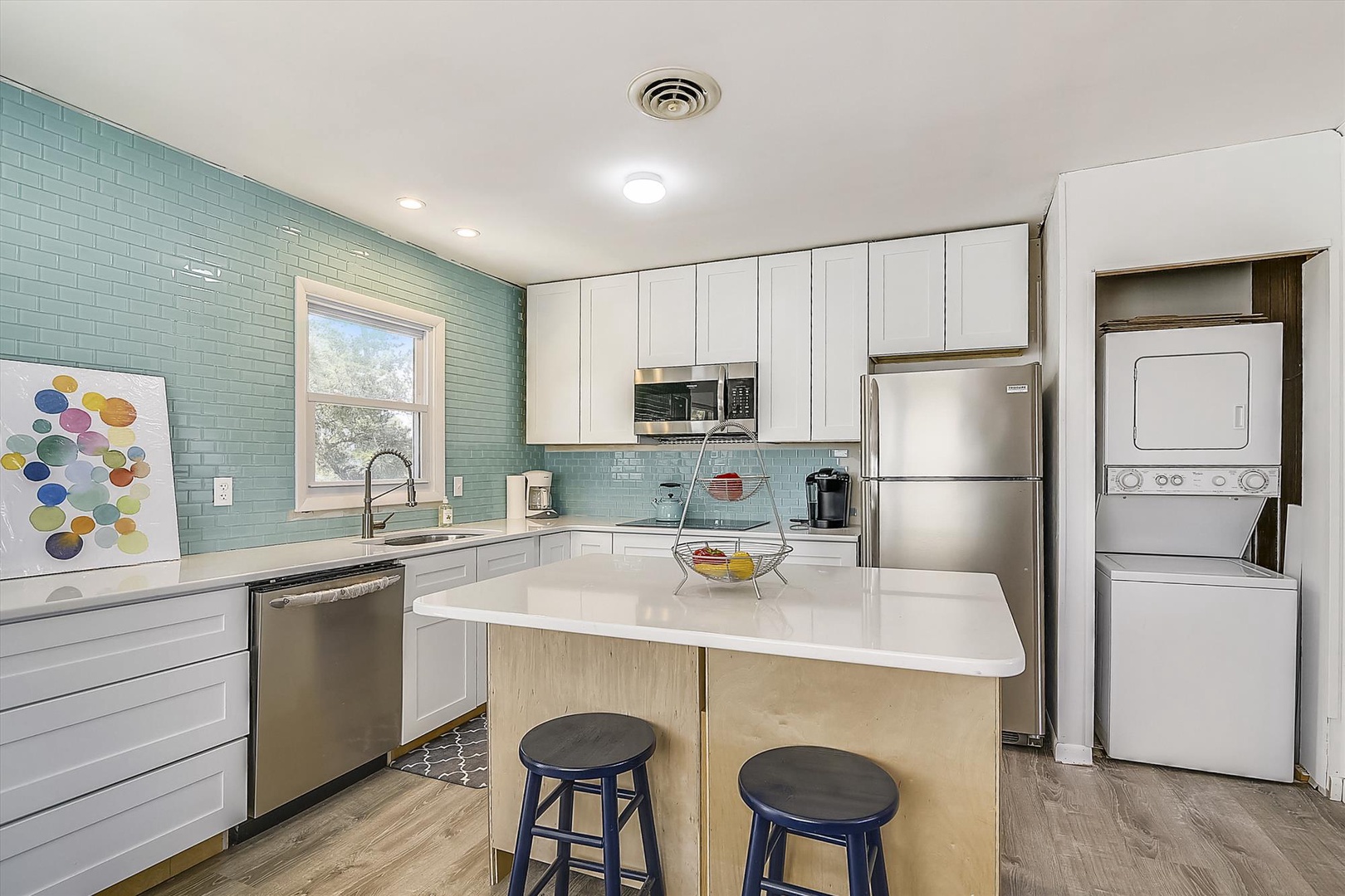 Your bright, fully-equipped kitchen awaits, complete with modern appliances and a welcoming island for meal prep or casual dining.