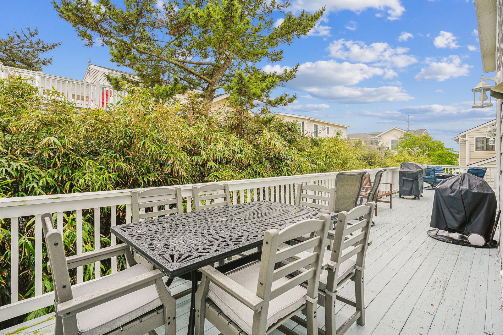 This spacious deck offers a perfect spot for your morning coffee or evening barbecue, surrounded by lush greenery and peaceful neighborhood views under open skies.