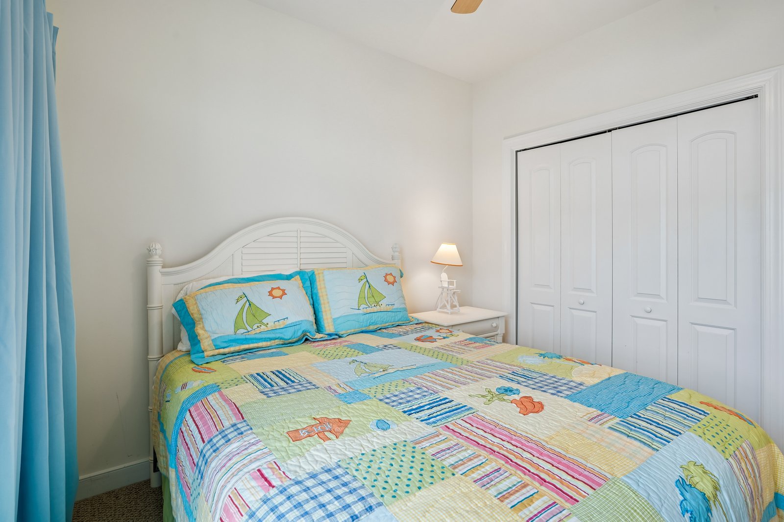 Your cozy bedroom features cheerful nautical bedding and ocean-themed decor, creating the perfect coastal retreat for peaceful nights.