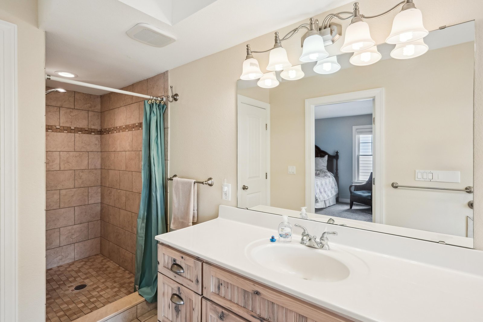 Freshen up in your private bathroom with a spacious walk-in shower, generous counter space, and thoughtful touches like soft lighting and fluffy towels waiting for you.