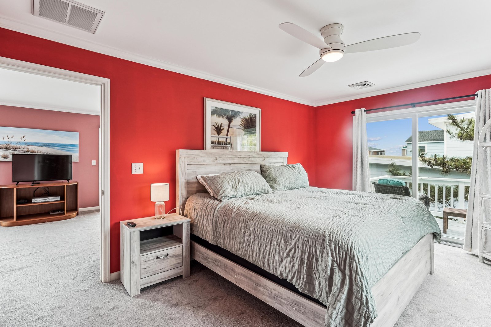 Wake up to soft natural light and coastal air flowing through your private space. The bold coral walls add warmth while the plush bed invites you to unwind. Step outside to your balcony and soak in the surrounding views.