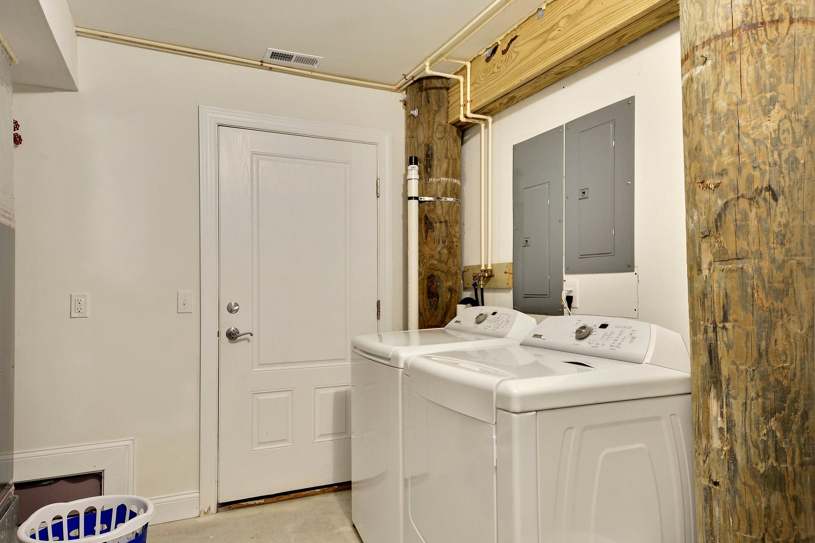 Your private laundry room features a washer and dryer for your convenience, framed by charming reclaimed wood beams that add rustic character.